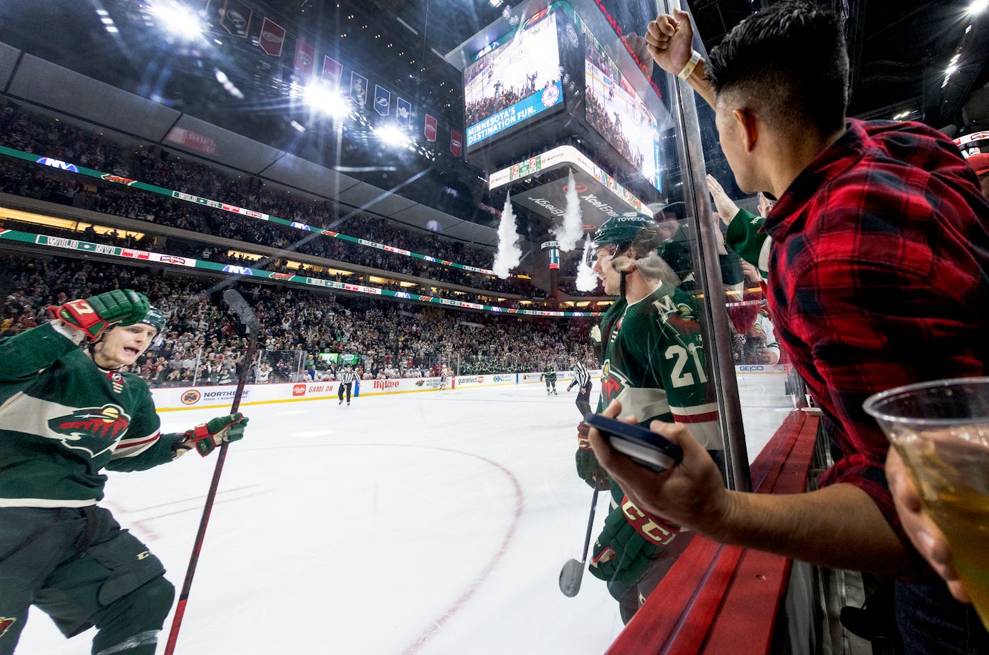 Nico Sturm (7) and Brandon Duhaime (21) of the Wild celebrate a goal by Duhaime in the third period