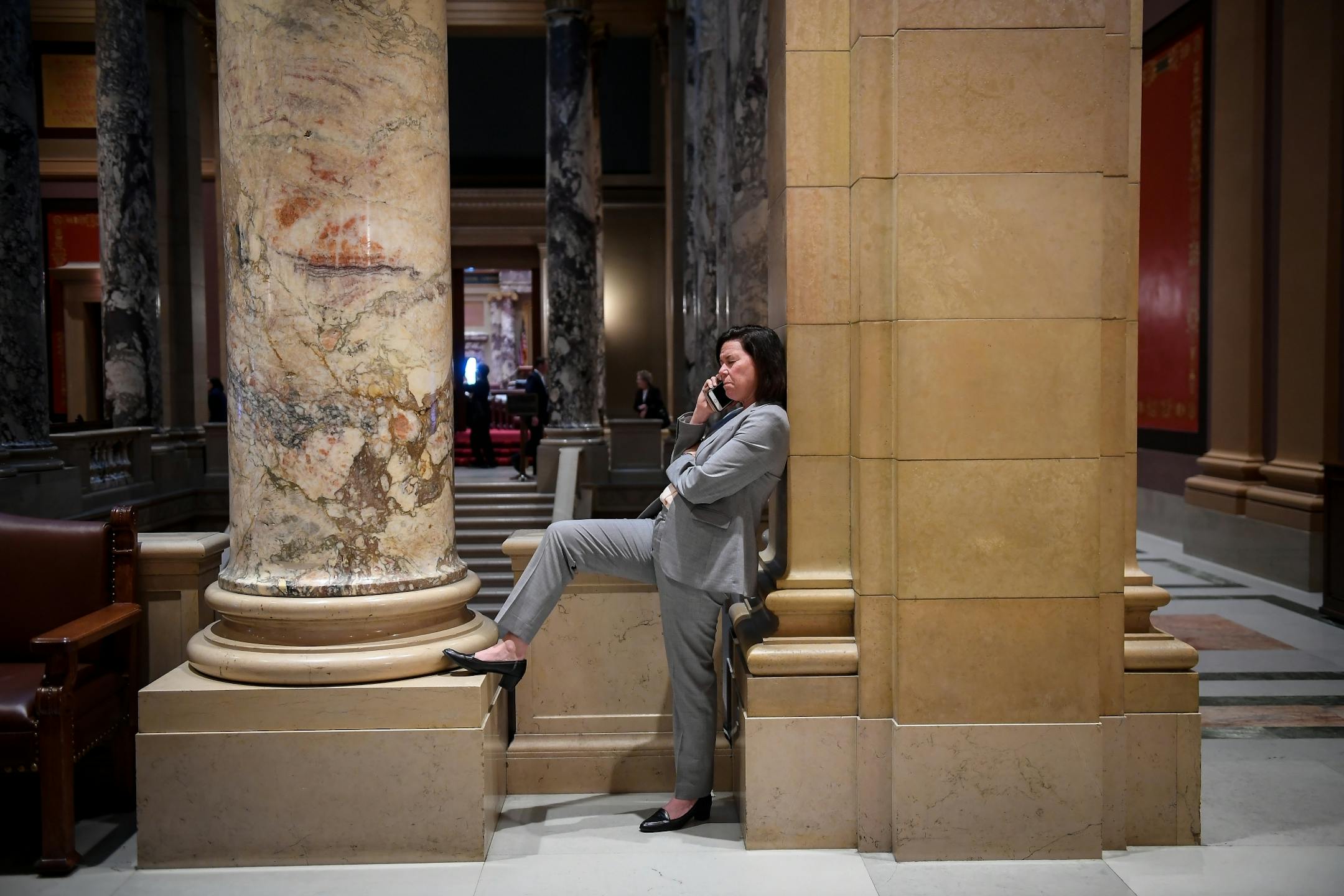 Molly Sigel, of Deephaven, talked on the phone during a recess in the legislative special session Tuesday. Sigel is the director of government relations for the law firm, Dorsey and Whitney, and is monitoring a number of bills for clients including the health and human services bill and the tax bill that could face a vote Tuesday night.
