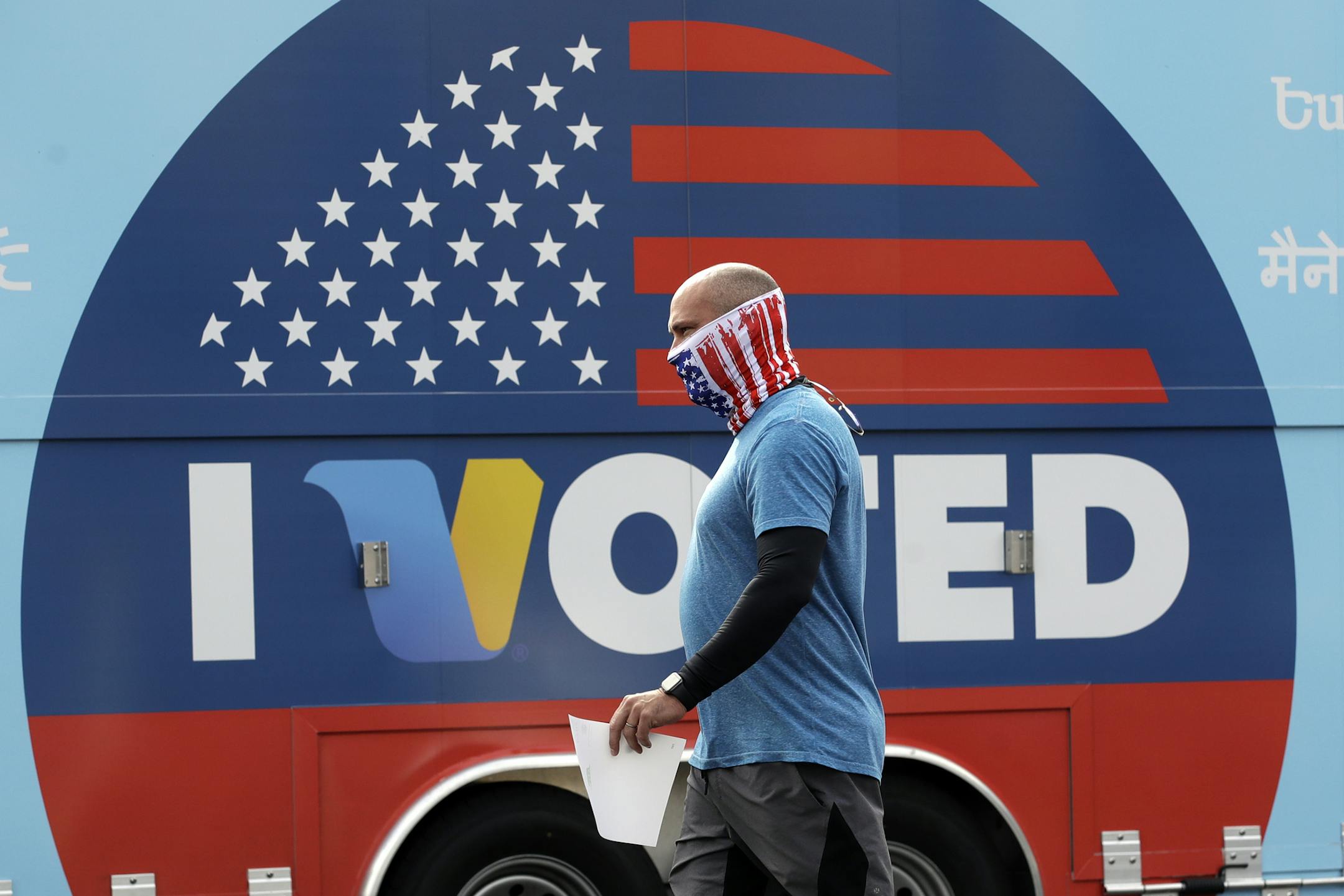 Robb Rehfeld wears a mask as he walks to cast his vote during a special election for California's 25th Congressional District seat Tuesday, May 12, 2020, in Santa Clarita, Calif. Republican Mike Garcia and Democrat Christy Smith are running for the seat after the resignation of Rep. Katie Hill, D-Calif. (AP Photo/Marcio Jose Sanchez)