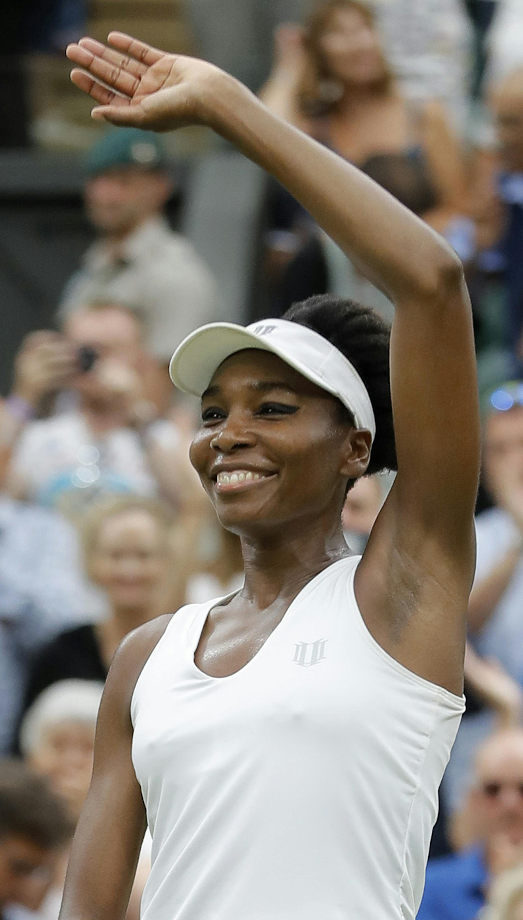 Venus Williams of the United States celebrates after beating Latvia's Jelena Ostapenko at the end of their Women's Quarterfinal Singles Match on day eight at the Wimbledon Tennis Championships in London Tuesday, July 11, 2017. (AP Photo/Alastair Grant)