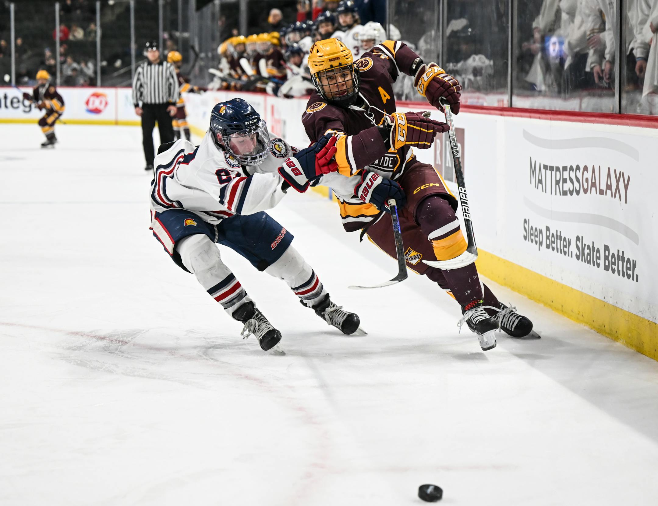 Northfield forward Kamden Kaiser (12) and Orono defenseman Joseph Mugaas (27) race for the puck during the first period.
