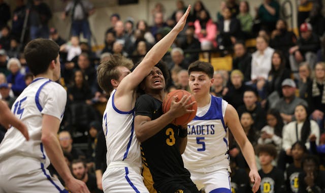 DeLaSalle's Nasir Whitlock drives the lane through St. Thomas Academy defender Michael Kirchner (3).