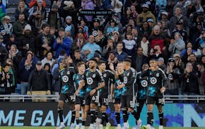 Minnesota United forward Tani Oluwaseyi, left, leads a group of jubilant Loons after scoring during the first half of Saturday against St. Louis City