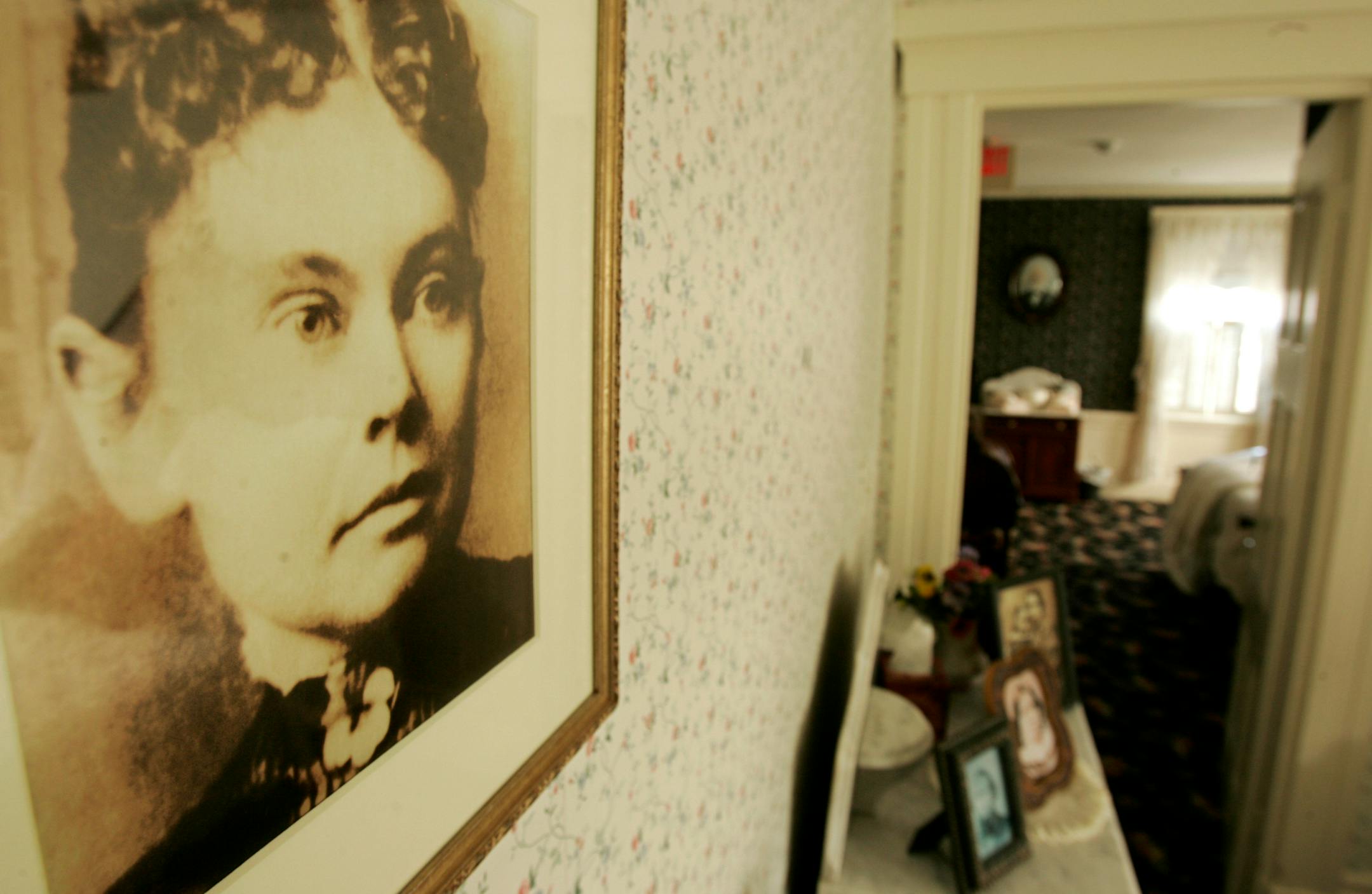 A photograph of Lizzie Borden appears in the Lizzie Borden Bed and Breakfast, in Fall River, Mass. The owner of the site of the 1892 double murder has filed a federal lawsuit to prevent a new museum and shop in Salem from using the name of the infamous former Sunday school teacher .