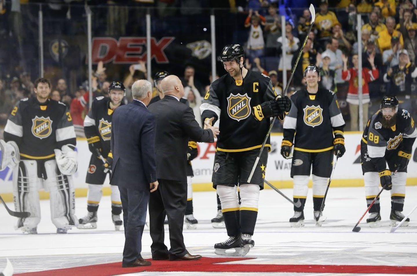 Pacific Division forward John Scott, center, is named most valuable player after the NHL hockey All-Star championship game Sunday, Jan. 31, 2016, in Nashville, Tenn.