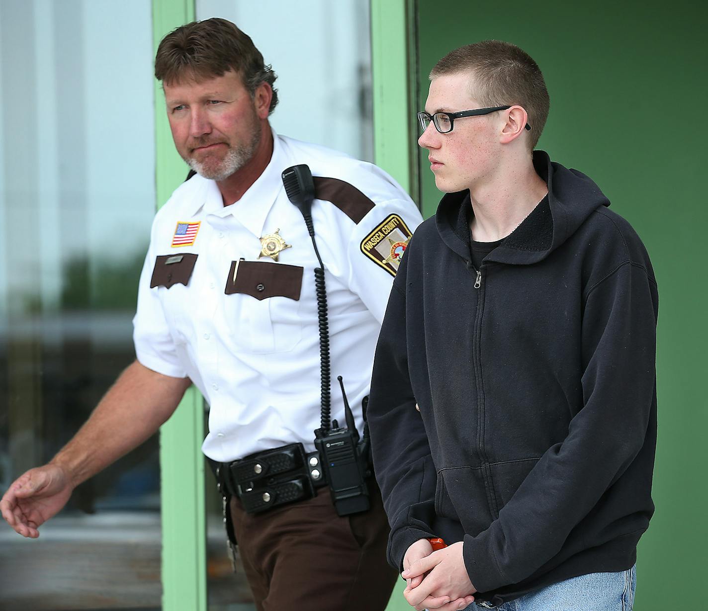 John LaDue, the would-be school shooter in Waseca, was escorted out of the Waseca County Cout House after he made an appearance in court for a hearing on whether he should be certified as an adult, Tuesday, June 30, 2015 in Waseca, MN. ] (ELIZABETH FLORES/STAR TRIBUNE) ELIZABETH FLORES &#x2022; eflores@startribune.com