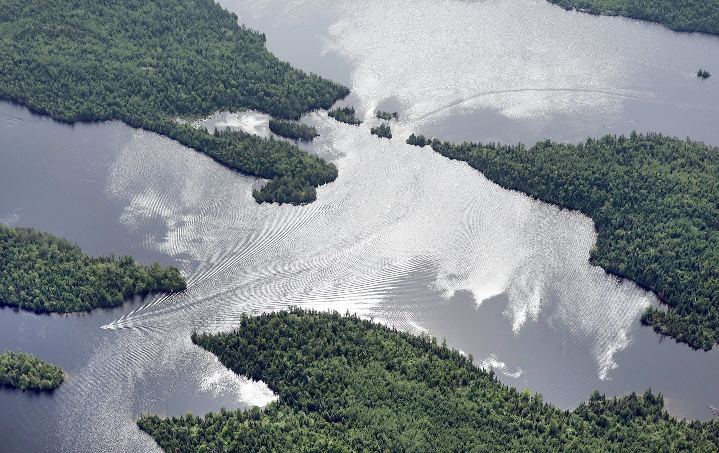 Photos by Bob King taken July 16, 2019, for Opinion Exchange/Editorial on Twin Metals, to publish November 24, 2019. Motorized boats slice through reflections of clouds on Newfound Lake in the BWCA.