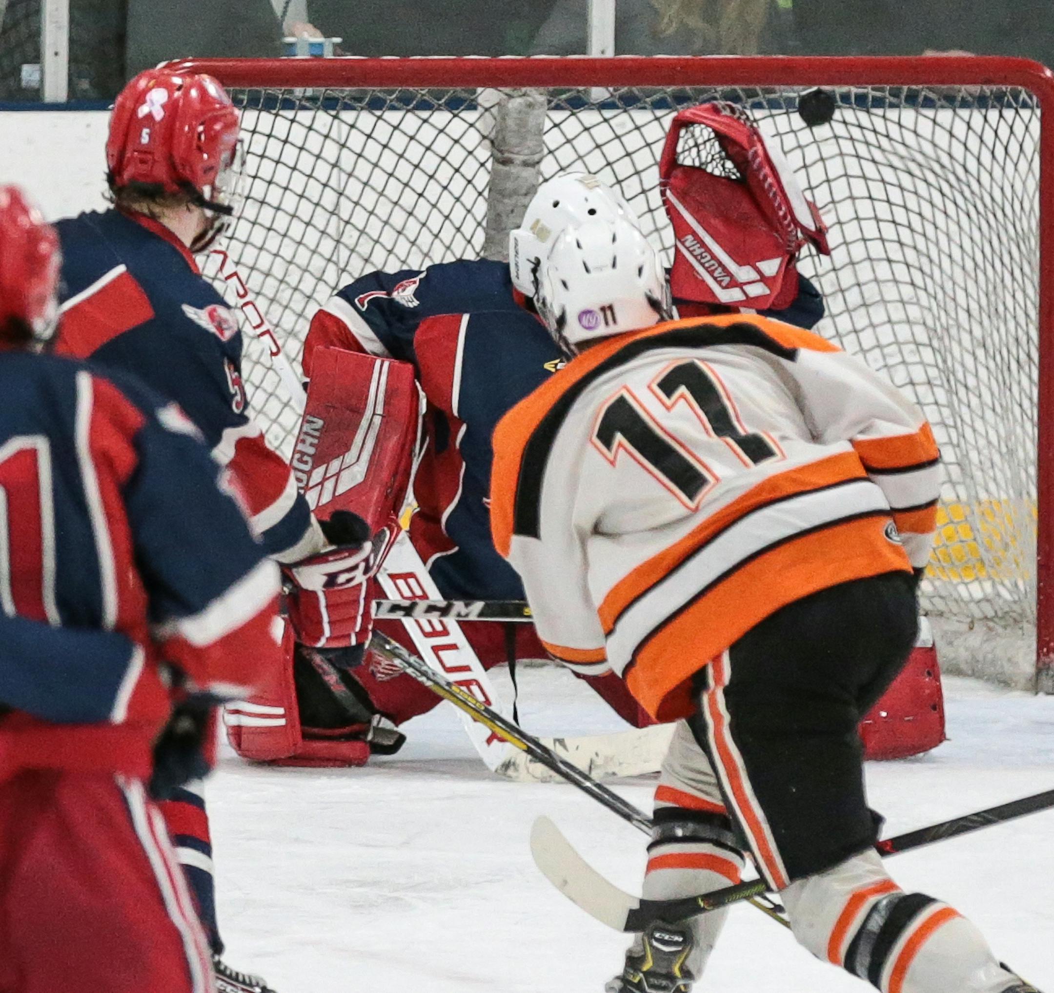Cheryl A. Myers, SportsEngine
Delano's Jesse Peterson (11) watches his puck hit the back of the net, scoring the game-winning goal in double overtime of the Class 1A, Section 2 final. Photo by Cheryl A. Myers, SportsEngine