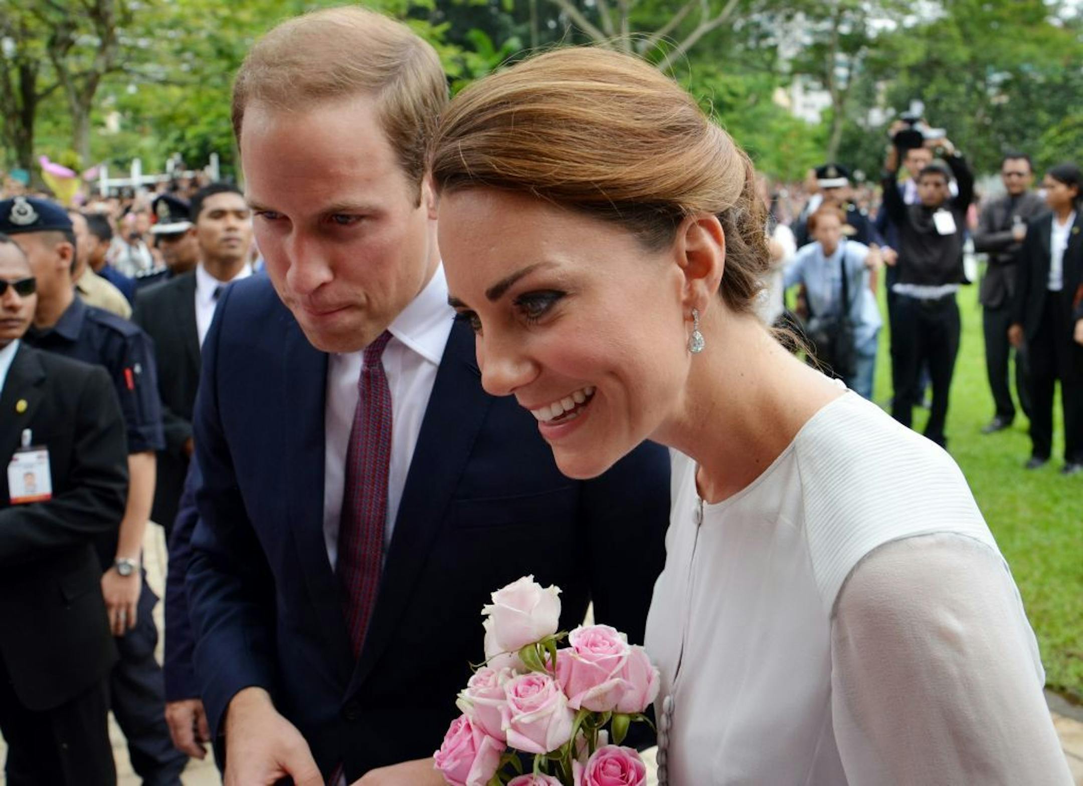 Britain's Prince William and his wife Kate, the Duke and Duchess of Cambridge smile to the public during a walk through a central city park in Kuala Lumpur, Malaysia, Friday, Sept. 14, 2012. Prince William and Kate are in Malaysia for a three-day visit as part of a tour to mark Queen Elizabeth II's Diamond Jubilee.