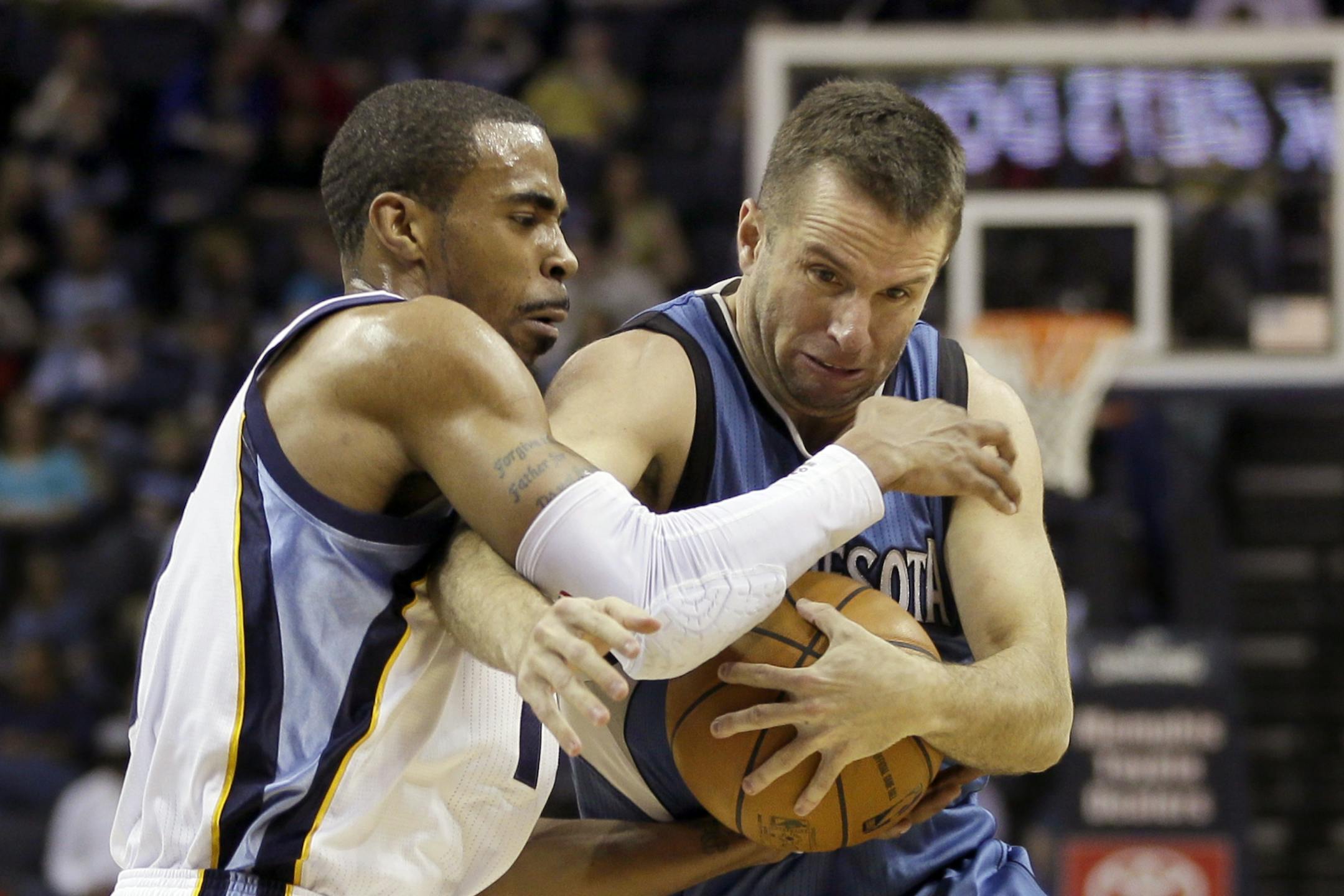 The Grizzlies' Mike Conley, left, pressured the Timberwolves' J.J. Barea during the first half in Memphis on Monday.