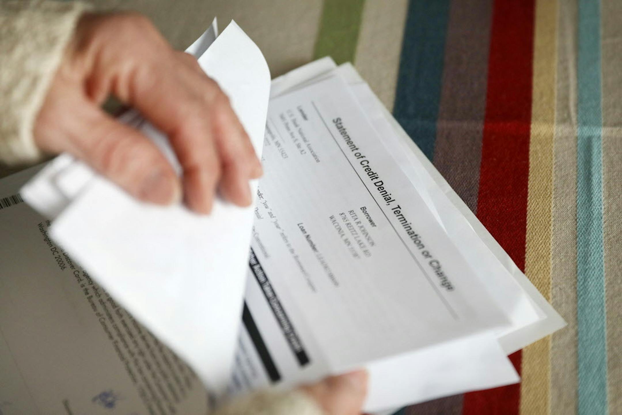 Rita Johnson shows some of the paperwork she's compiled in fighting her problems.