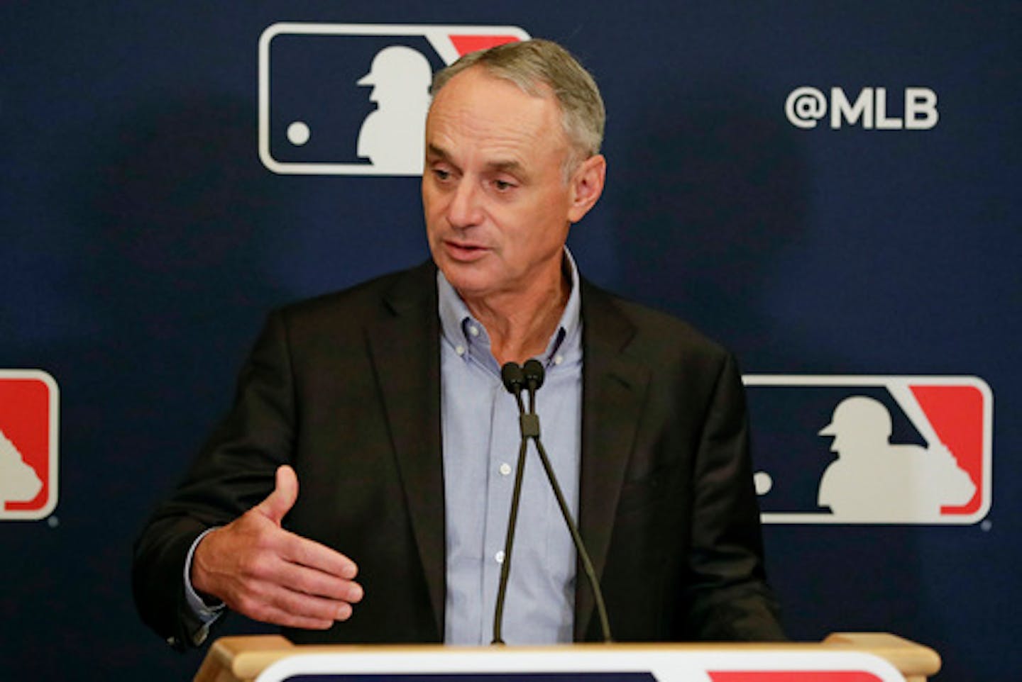 FILE - In this Feb. 6, 2020, file photo, Major League Baseball Commissioner Rob Manfred answers questions at a news conference during MLB baseball owners meetings in Orlando, Fla. Major League Baseball will cuts its amateur draft from 40 rounds to five this year, a move that figures to save teams about $30 million. Clubs gained the ability to reduce the draft as part of their March 26 agreement with the players' association and MLB plans to finalize a decision next week to go with the minimum, a person familiar with the decision told The Associated Press. The person spoke Friday, May 8, 2020, on condition of anonymity because no decision was announced. (AP Photo/John Raoux, File)