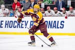 Gophers defenseman Cal Thomas controls the puck against Boston University in the NCAA tournament in Sioux Falls on March 30.