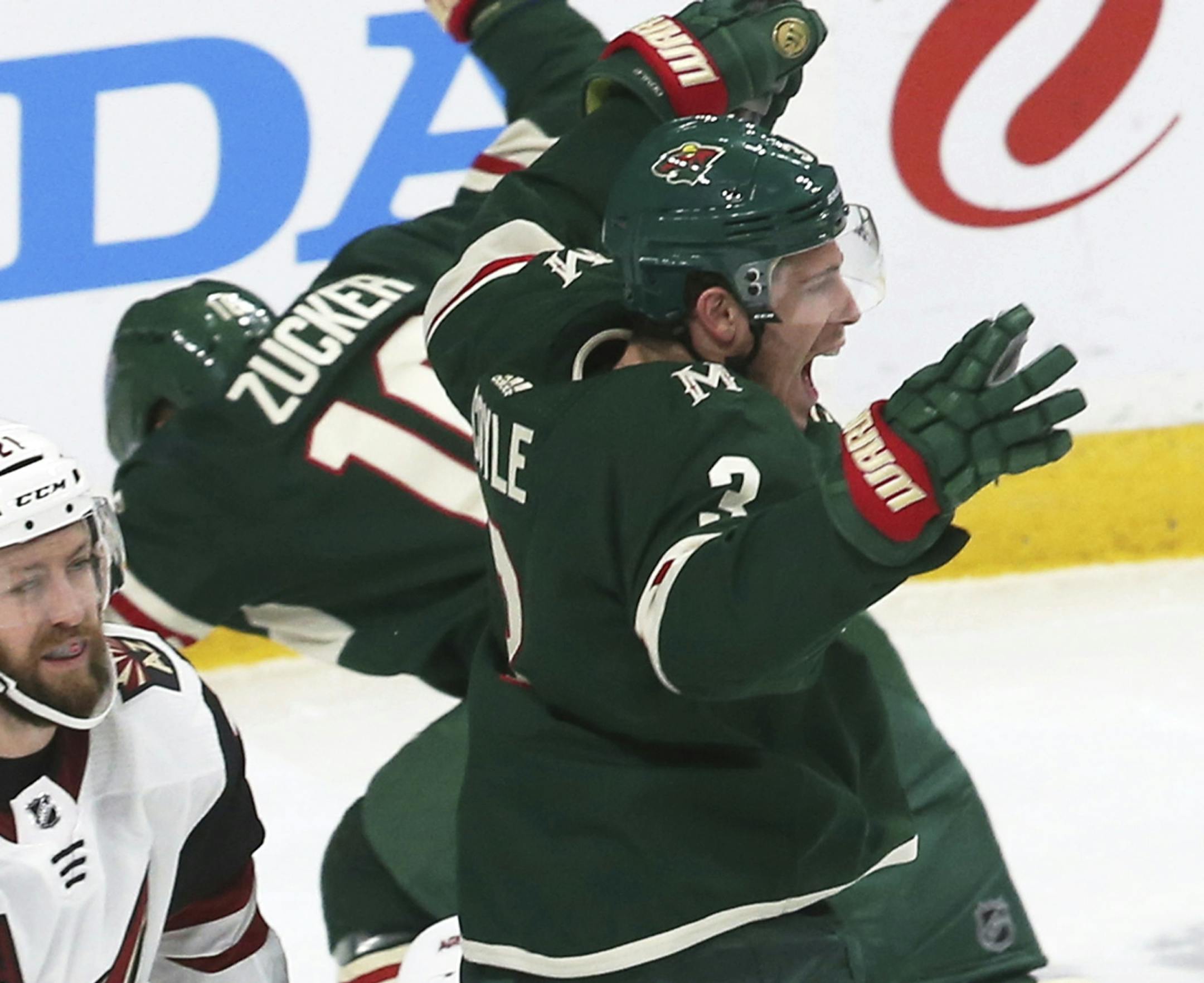Minnesota Wild's Charlie Coyle, right, celebrates the go-ahead goal by Eric Staal off Arizona Coyotes goalie Darcy Kuemper in the third period of an NHL hockey game, Tuesday, Oct. 16, 2018, in St. Paul, Minn. The Wild won 2-1. (AP Photo/Jim Mone)