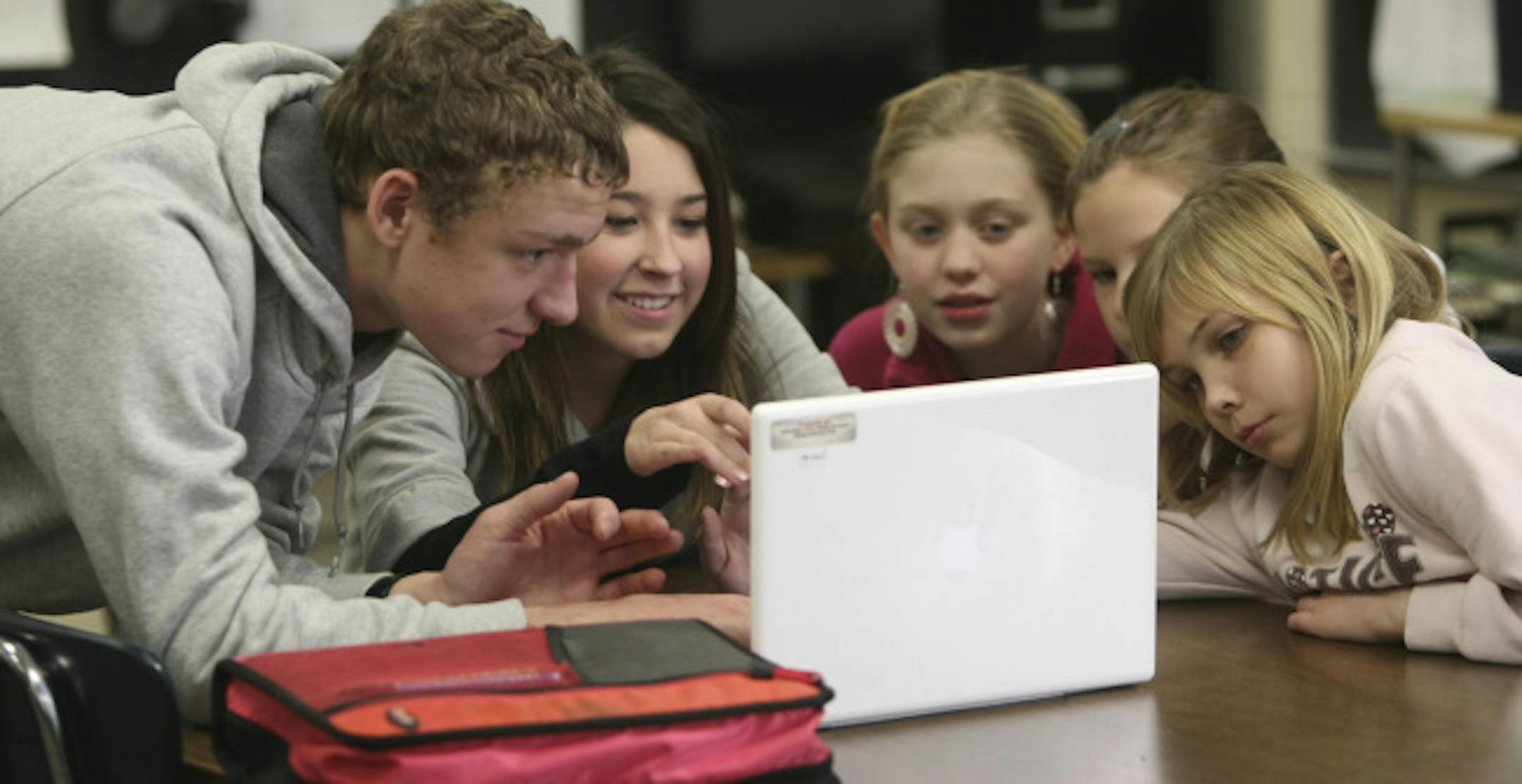 From the left, Ryan Mathiew and Bailee Droel of Cutaway Productions helped Stonebridge Elementary School students Sabrina Storms, Summer Thompson and Vanessa Johnson make short movies on a Mac computer.