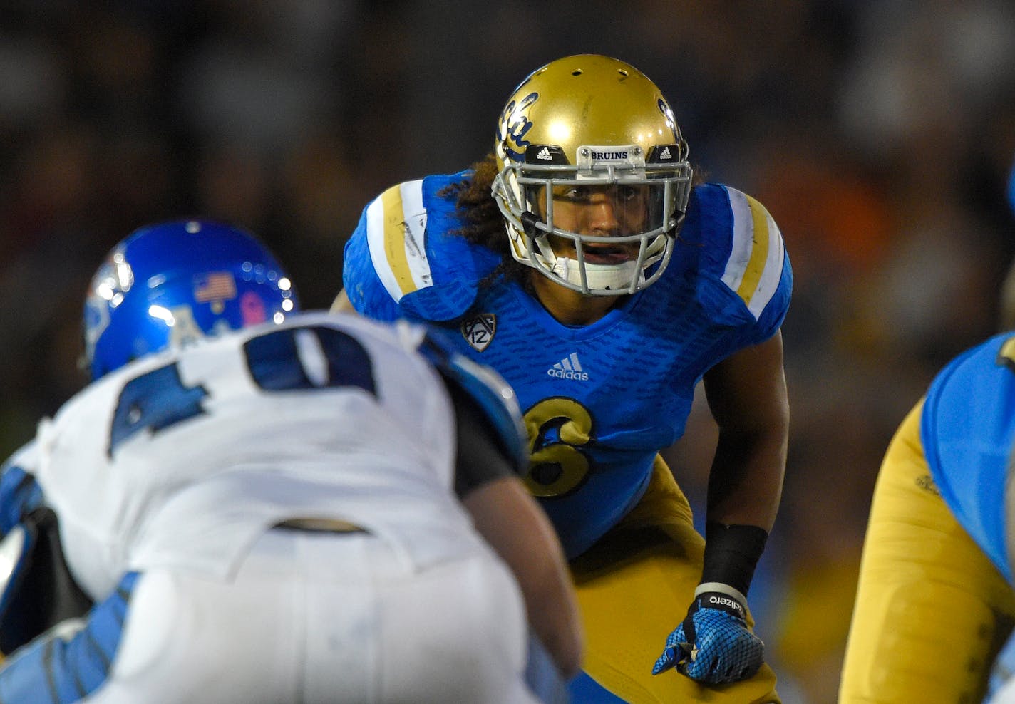 UCLA linebacker Eric Kendricks, right, waits for the snap along with Memphis tight end Alan Cross during the second half of an NCAA college football game, Saturday, Sept. 6, 2014, in Pasadena, Calif. UCLA won 42-35. (AP Photo/Mark J. Terrill)