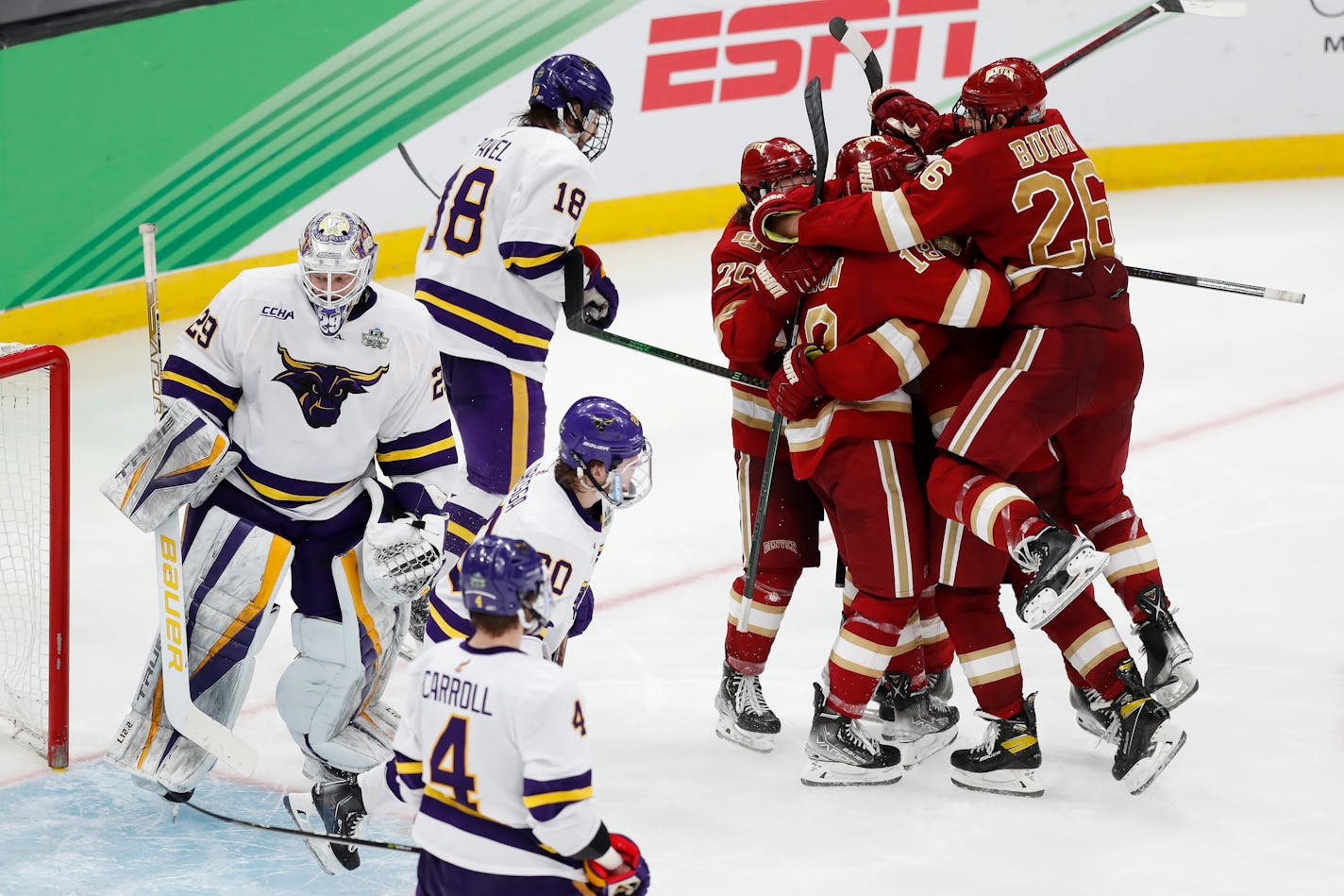 Denver's Shai Buium (26) and teammates celebrate a goal by Ryan Barrow against Minnesota State's Dryden McKay (29) during the third period of the NCAA men's Frozen Four championship college hockey game Saturday, April 9, 2022, in Boston. (AP Photo/Michael Dwyer)