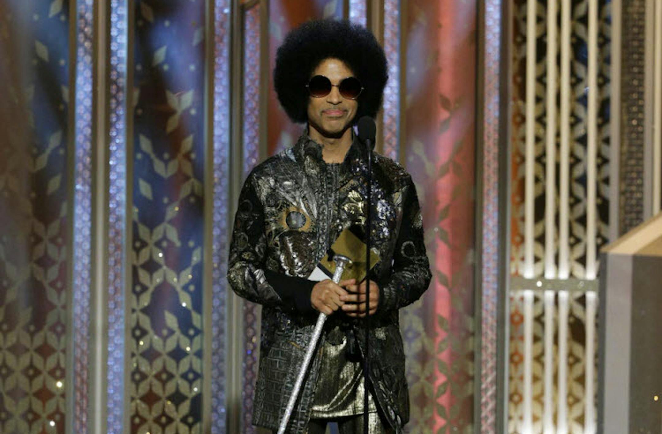 In this image released by NBC, Prince presents an award at the 72nd Annual Golden Globe Awards on Sunday, Jan. 11, 2015, at the Beverly Hilton Hotel in Beverly Hills, Calif. (AP Photo/NBC, Paul Drinkwater)