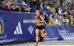 Emma Bates of Elk River crosses the finish line of the Boston Marathon on Monday, finishing as the top American woman for the second year in a row.