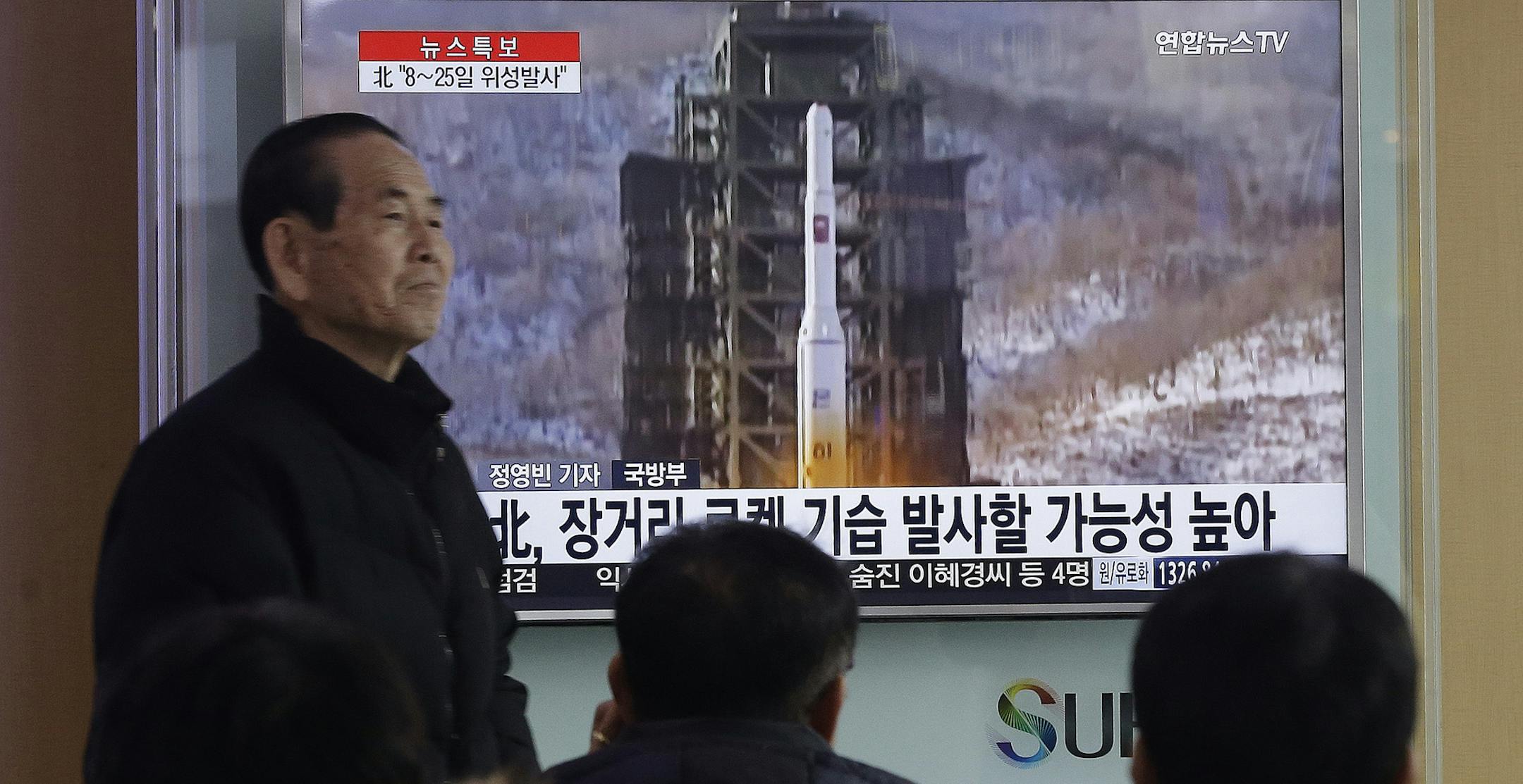 South Koreans watch a TV news program with a file footage about North Korea's rocket launch plans at Seoul Railway Station in Seoul, South Korea, Wednesday, Feb. 3, 2016. South Korea warned on Wednesday of "searing" consequences if North Korea doesn't abandon plans to launch a long-range rocket that critics call a banned test of ballistic missile technology. The headline on the screen read "North Korea plans to launch a long-rang rocket." (AP Photo/Ahn Young-joon) ORG XMIT: MIN2016021112255632