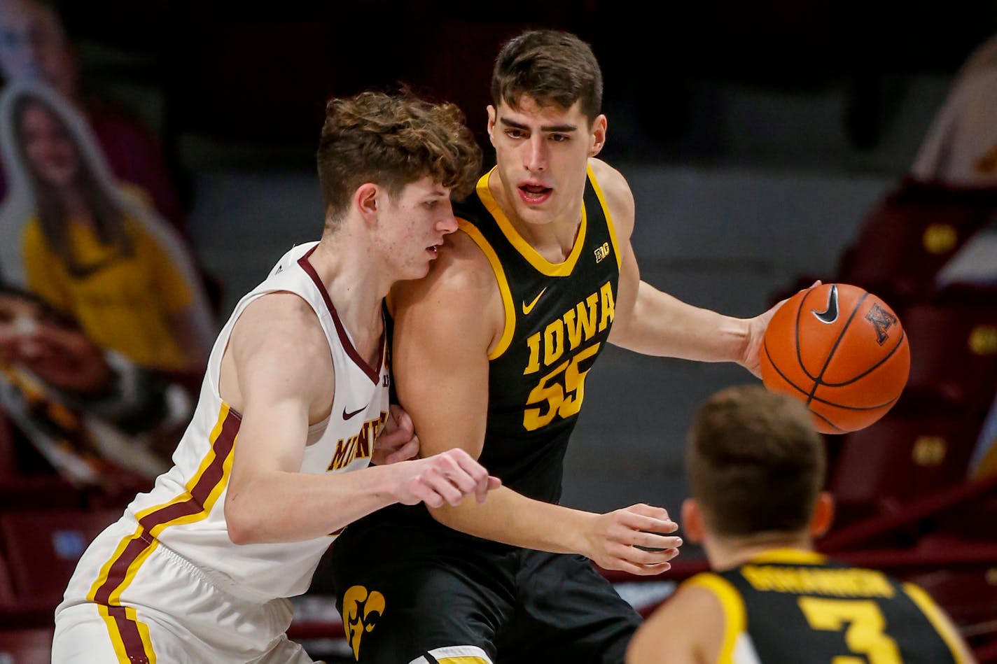 Minnesota center Liam Robbins defends against Iowa center Luka Garza (55) during the first half of an NCAA college basketball game Friday, Dec. 25, 2020, in Minneapolis. (AP Photo/Bruce Kluckhohn)