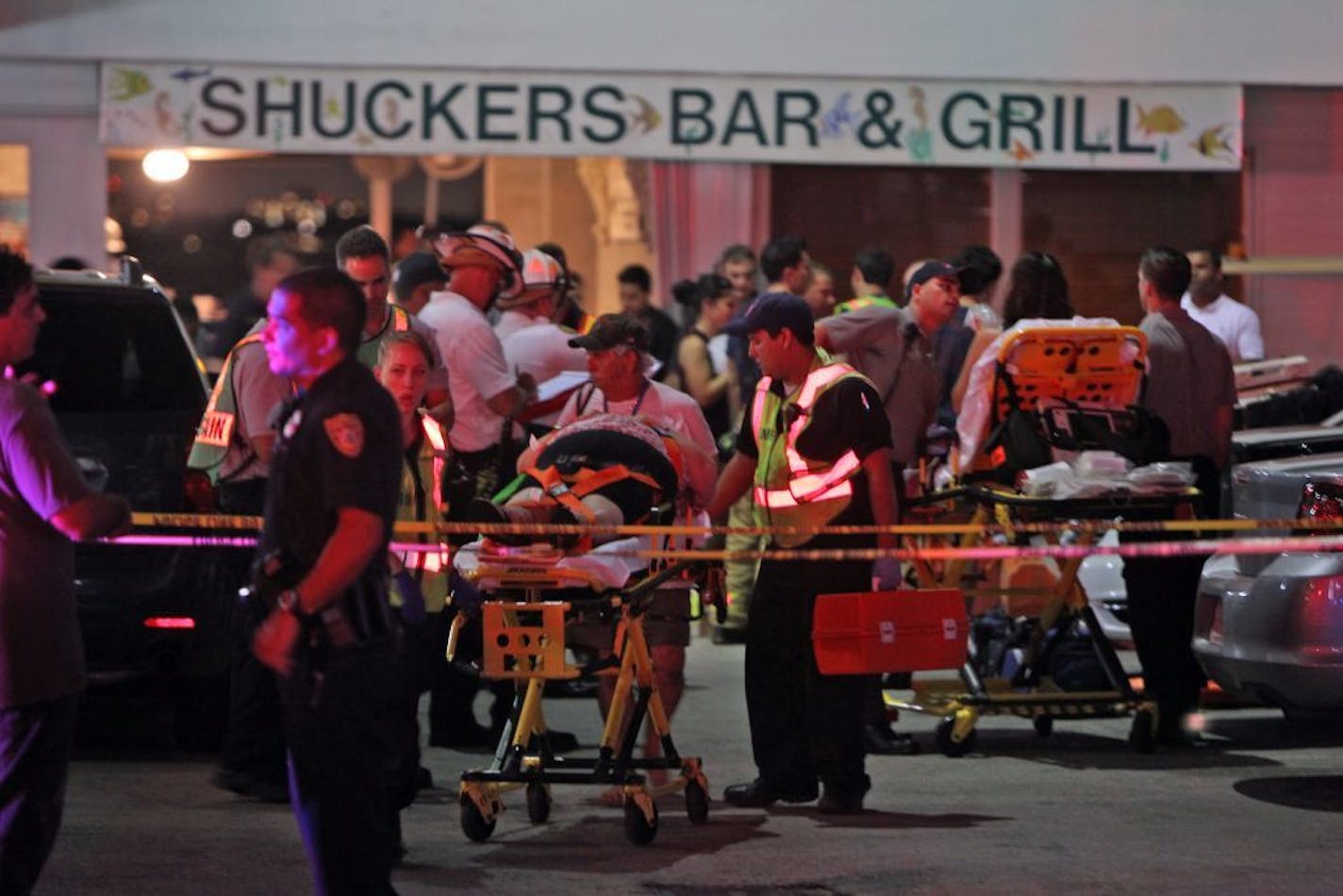 Rescuers transport an injured patron after a packed outdoor deck collapsed at a popular Miami-area sports bar Thursday June 13, 2013.