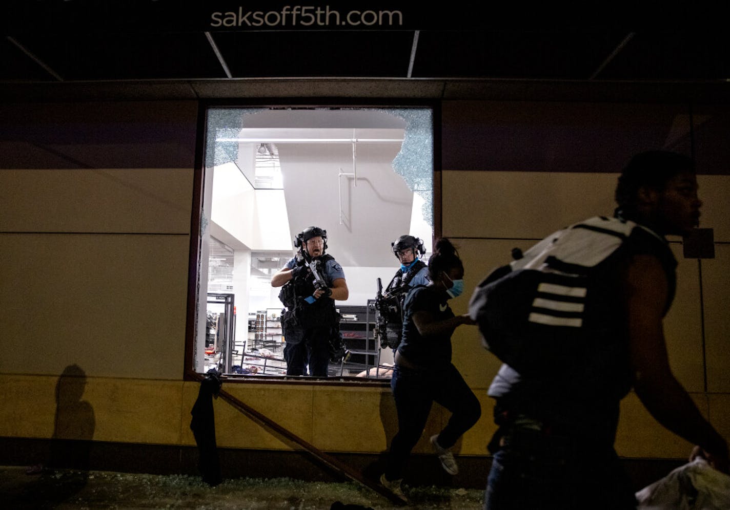 Police cleared out and secured Saks Off 5th in downtown Minneapolis on Wednesday night after unrest that included looting and smashing of windows.