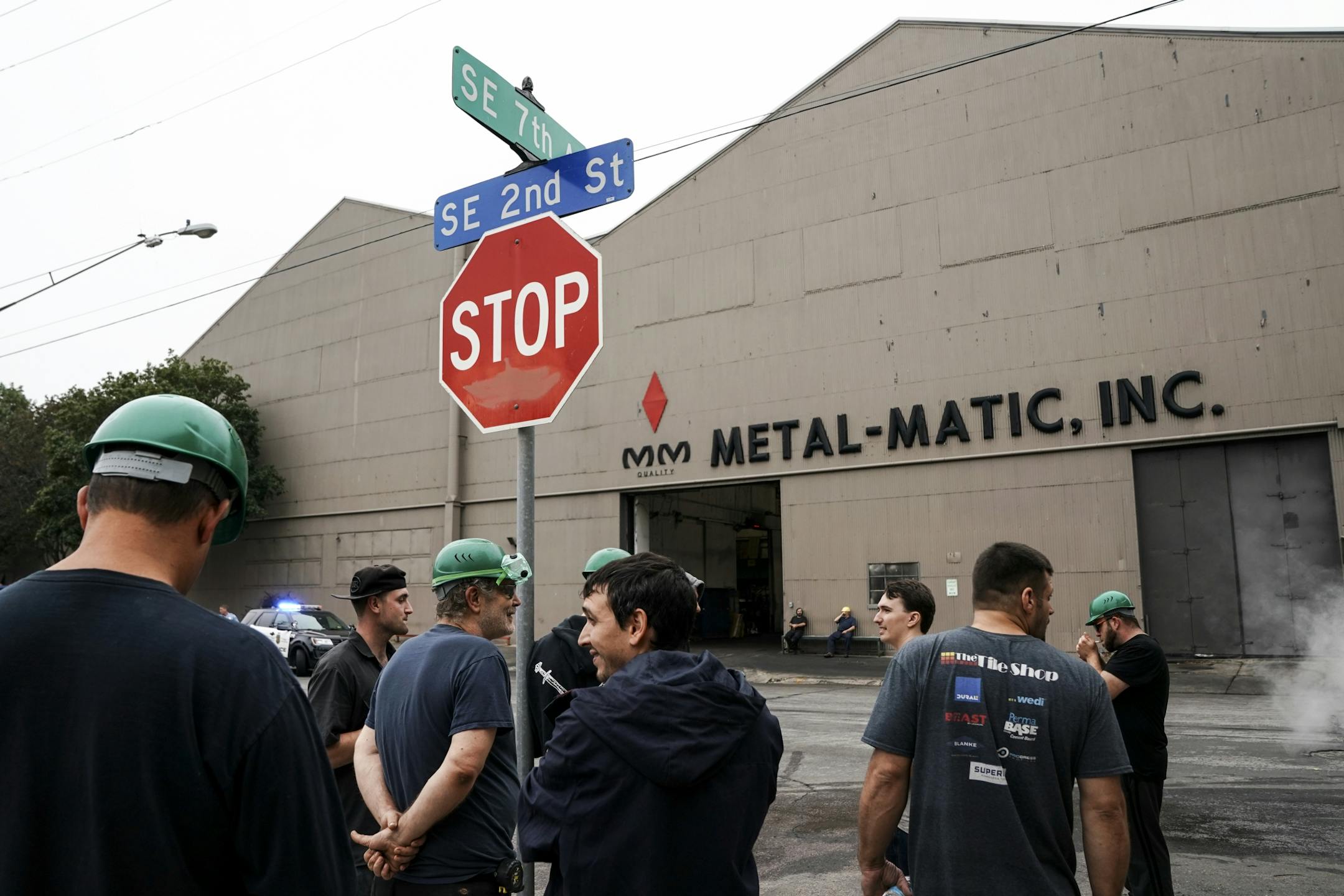 Evacuated workers waited across the street from Metal-Matic after an explosion and fire Wednesday afternoon.