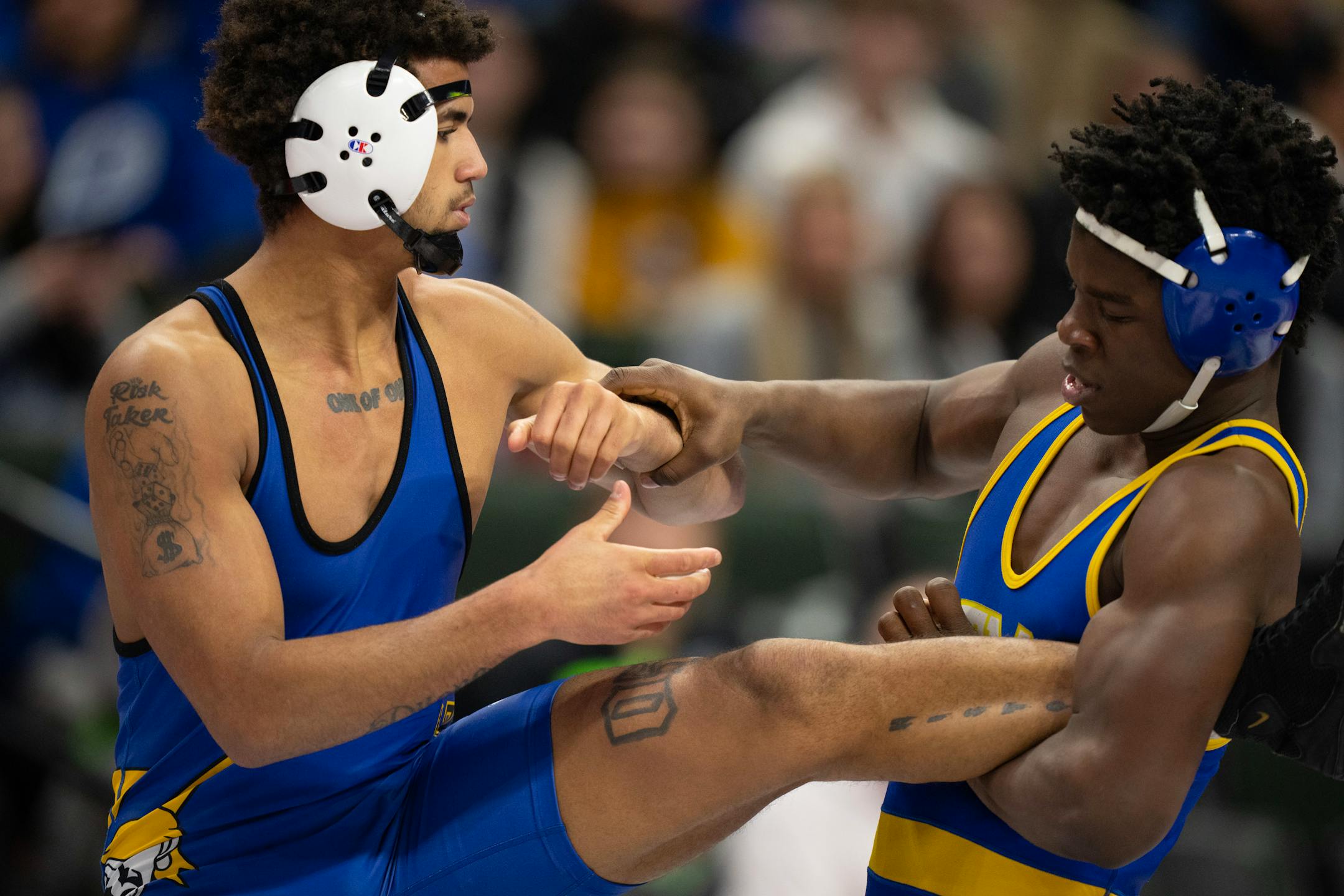 Jericho Cooper of Hastings, left, on his way to a 14-8 decison over Bryon Sauvy of St. Michael-Albertville in their 182 lb. match.