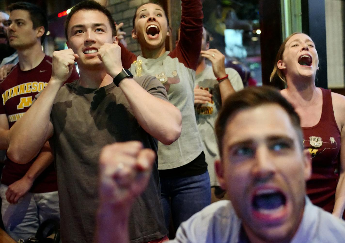 Left to right: former U of M swimmer Colin Lee-To, friend Lindsay Helmila, Amy Kohl, and former U of M swimmer Tim Loeffler(foreground) cheered David Plummer to a bronze medal 100M backstroke.]David Plummer, a former U of M swimmer will be cheered by his former teammates at Sally's Saloon.Richard Tsong-taatarii@startribune.com