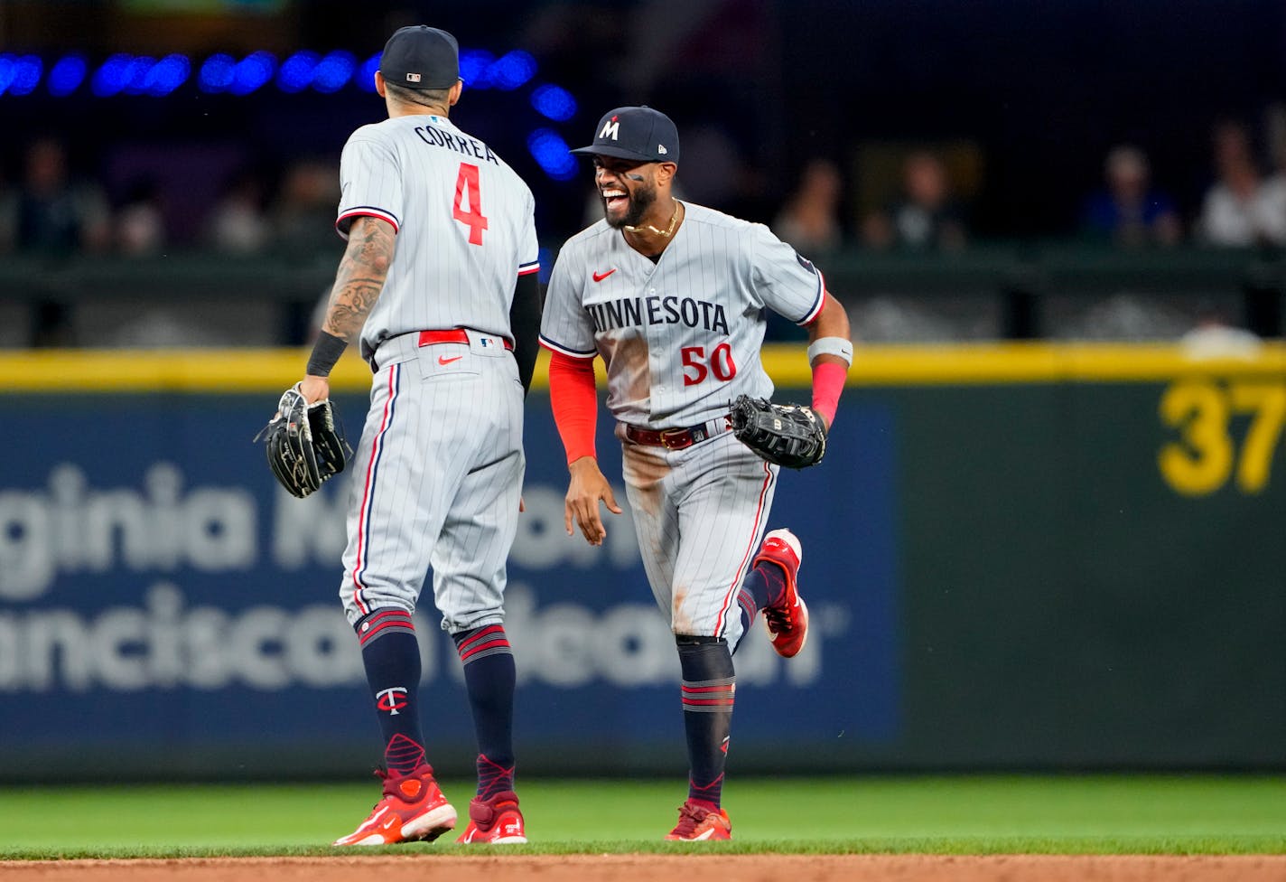 Minnesota Twins' Carlos Correa, left, greets teammate Willi Castro (50) as they celebrate a 6-3 win over the Seattle Mariners in a baseball game, Wednesday, July 19, 2023, in Seattle. (AP Photo/Lindsey Wasson)