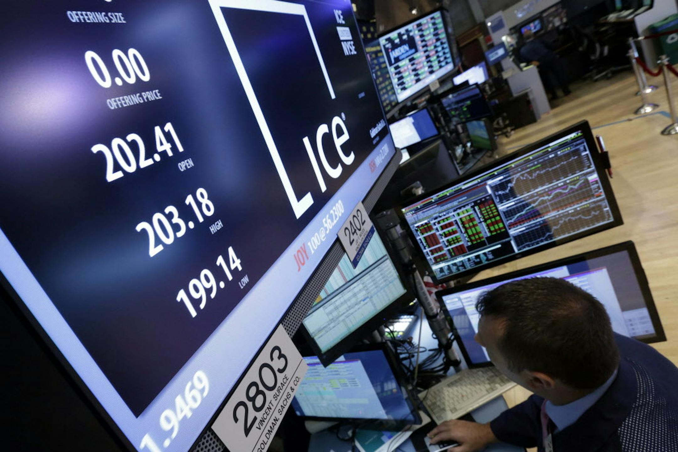 Specialist Vincent Surace works at the post on the floor of the New York Stock Exchange that handles Intercontinental Exchange, Tuesday, Nov. 12, 2013. The ICE and NYSE Euronext tie-up will close Wednesday. (AP Photo/Richard Drew) ORG XMIT: MIN2013111815025247