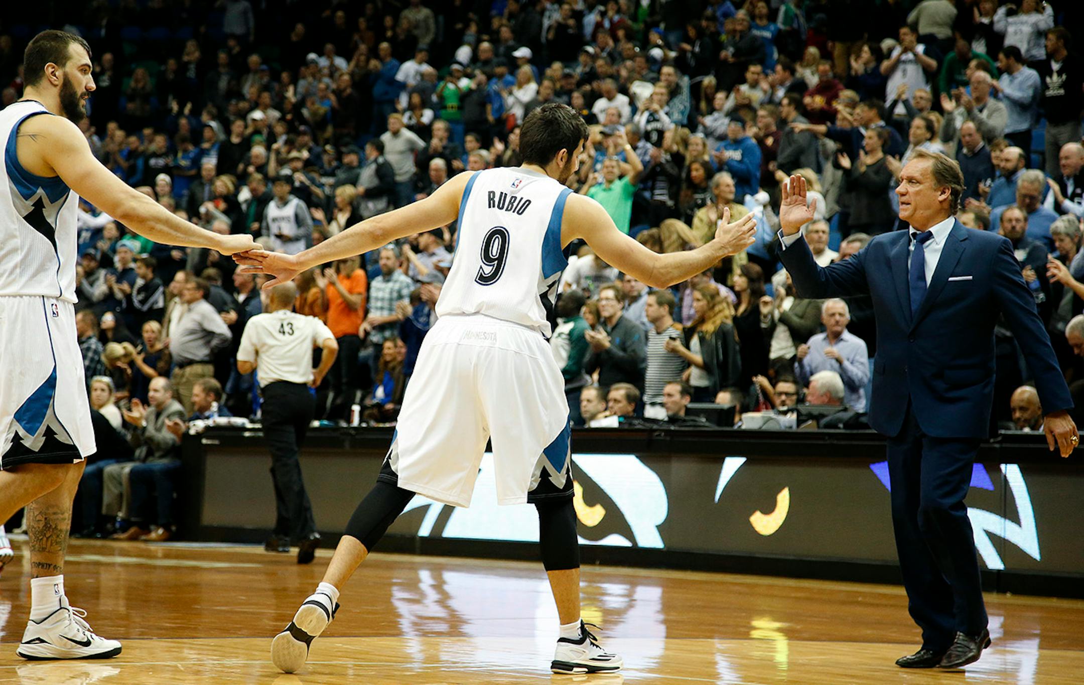 Nikola Pekovic (14), Ricky Rubio (9) and Flip Saunders celebrated at the end of the game. Minnesota beat Detroit by a final score of 97-91. ] CARLOS GONZALEZ cgonzalez@startribune.com - October 30, 2014, Minneapolis, Minn., Target Center, NBA, Minnesota Timberwolves vs. Detroit Pistons, Home Opener