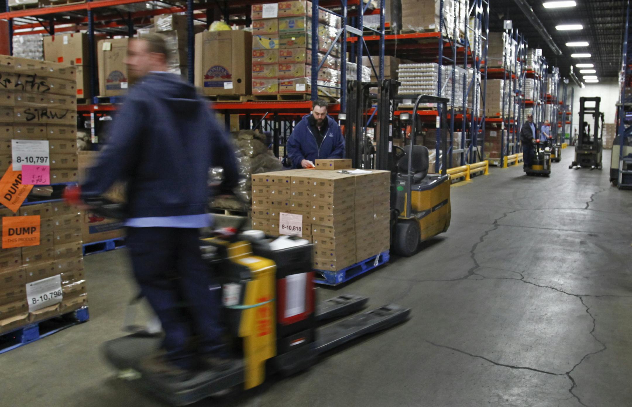 Material handlers work in the warehouse at Second Harvest Heartland, which receives donations from grocery stores such as Lunds & Byerlys, Cub Foods and Kowalski's.