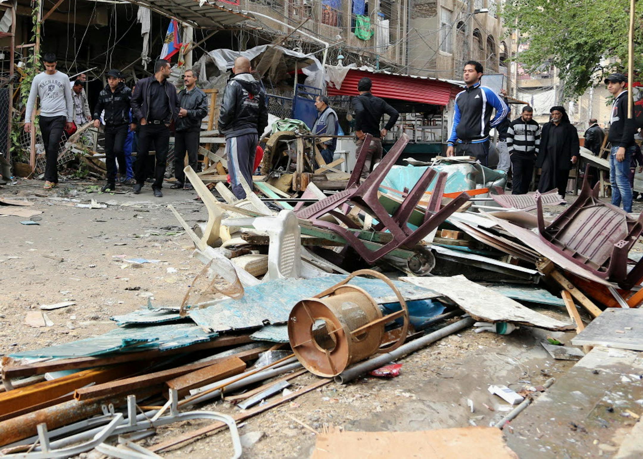 Iraqis inspect the aftermath of a late-night bombing at a cafe in Bayaa neighborhood, southwestern Baghdad, Iraq, Thursday, Nov. 21, 2013.
