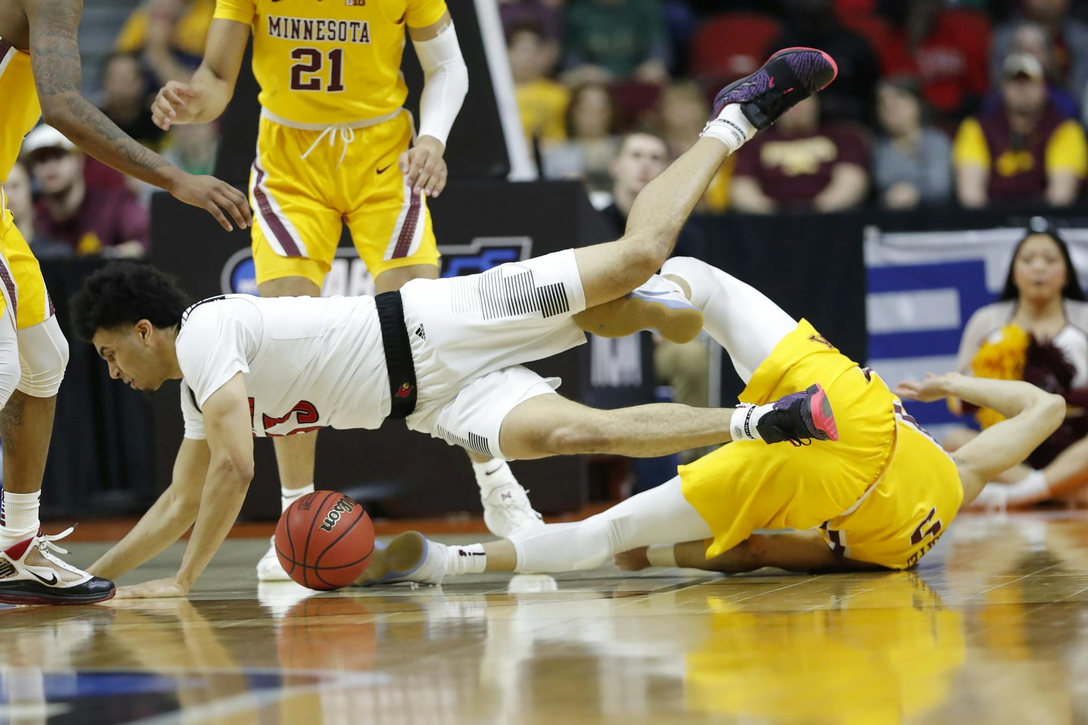 Louisville forward Jordan Nwora is fouled by Minnesota guard Amir Coffey, right, during a first round men's college basketball game in the NCAA Tournament, Thursday, March 21, 2019, in Des Moines, Iowa.