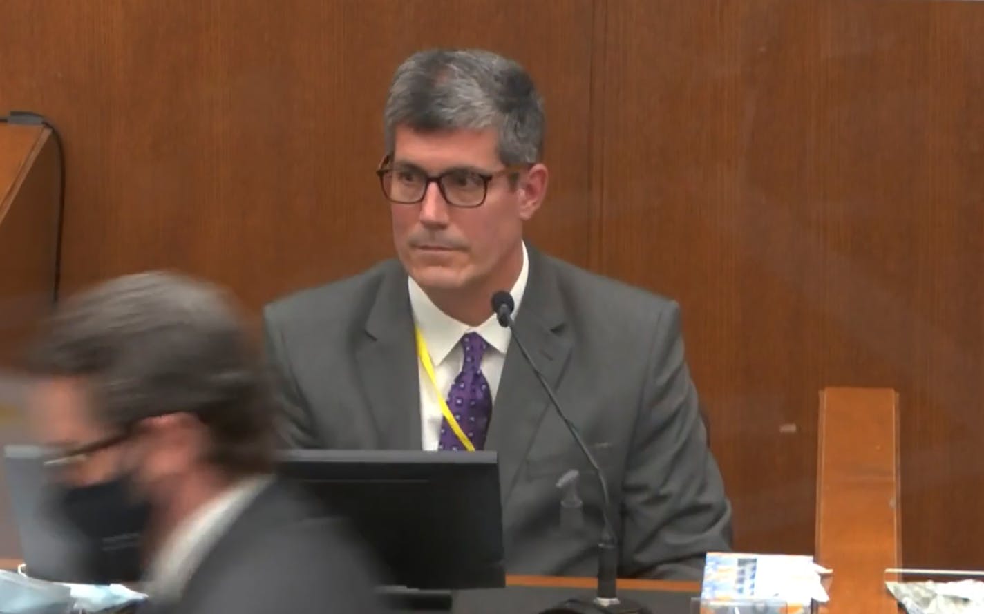 In this image from video, defense attorney Eric Nelson, left, walks away after presenting evidence to Dr. Andrew Baker, Hennepin County Chief Medical Examiner, as Hennepin County Judge Peter&nbsp;Cahill presides Friday, April 9, 2021, in the trial of former Minneapolis police Officer Derek Chauvin at the Hennepin County Courthouse in Minneapolis, Minn. Chauvin is charged in the May 25, 2020 death of George Floyd. (Court TV via AP, Pool)