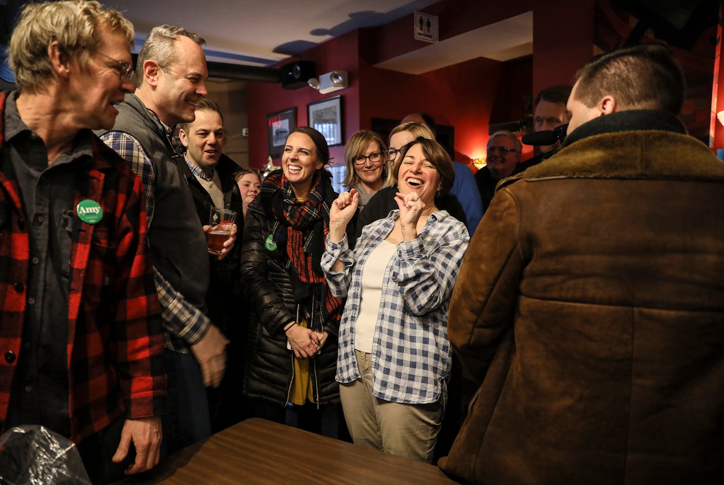 Sen. Amy Klobuchar, D-Minn., center, speaks to voters during a campaign stop at the Village Trestle in Goffstown, N.H., on Monday.