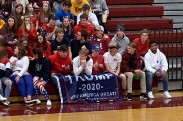 Michael Walker posted on Facebook a photograph of fans in Jordan with a Trump flag draped over the legs of four front-row spectators.