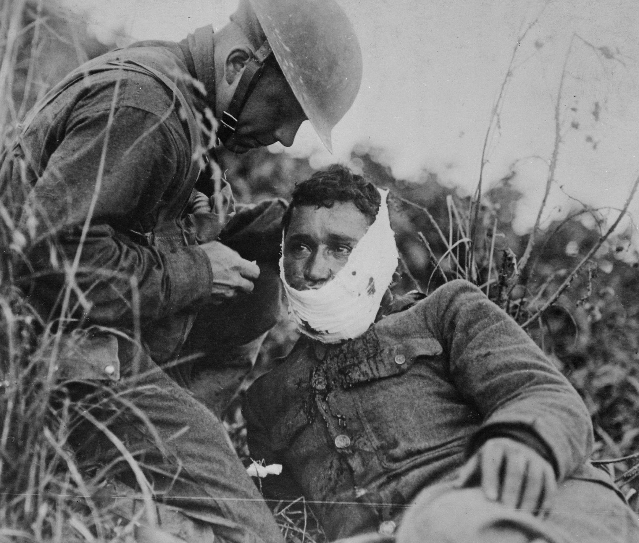 Credit: Courtesy of National Archives
Photo Caption
An American soldier wraps another soldierís head wound at Varennes-en-Argonne, France (September 1918)