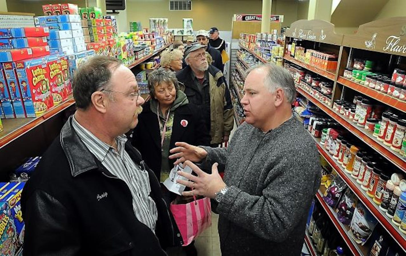 Constituents wait in line as U.S. Rep. Tim Walz, D-Minn., right, talks with Craig Jaskulke, a local trades union organizer, during a "Congress on Your Corner" meeting at a supermarket in Mankato, Minn. on Friday, Jan. 14, 2010. Walz held the meeting as a tribute to House colleague Rep. Gabrielle Giffords, D-Ariz., who was shot during a similar gathering in Tucson, Ariz. on Jan. 8, 2010.