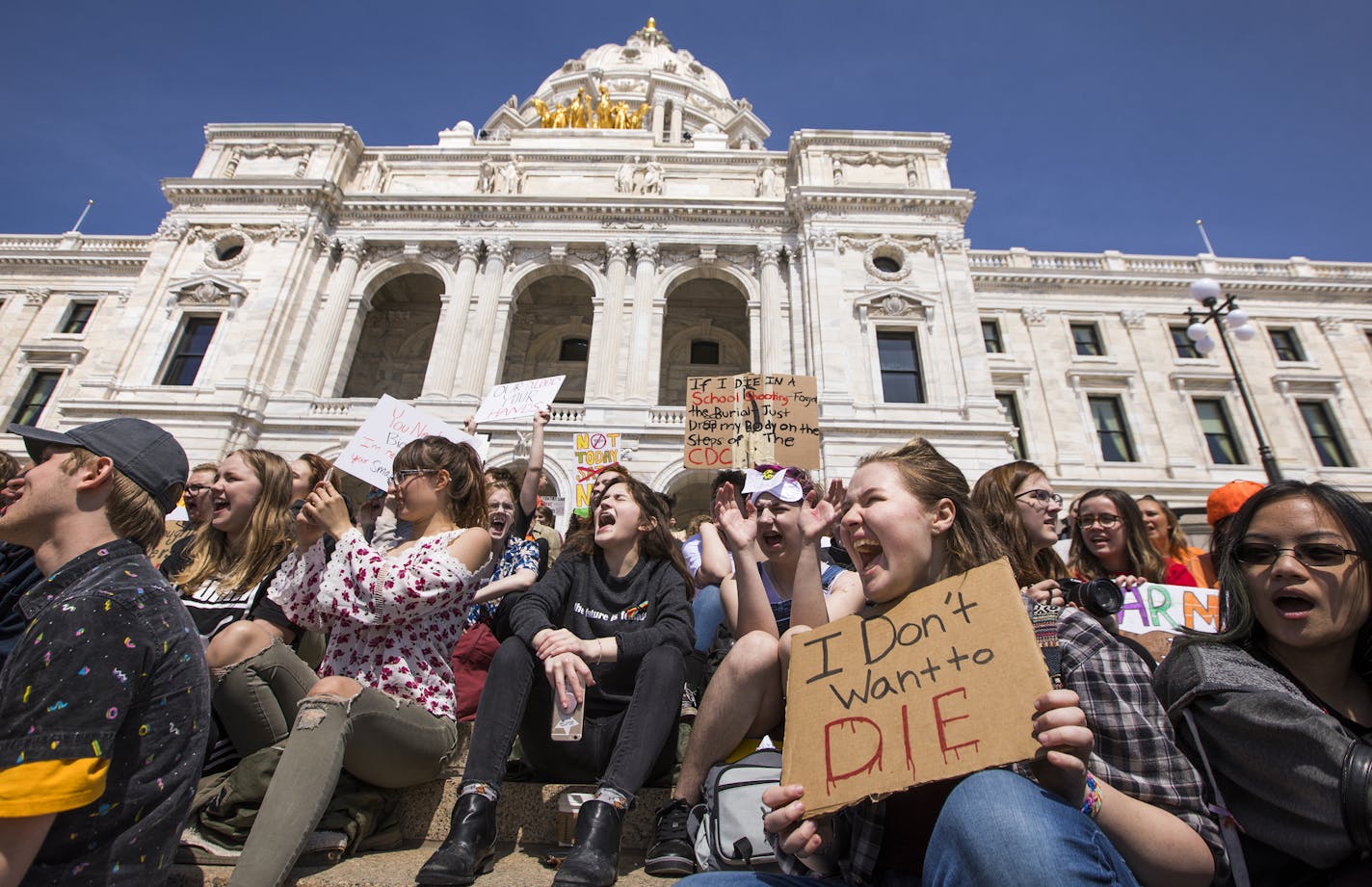 Cate Barnes, second from right, a junior at Avalon Charter School in St. Paul, chants with a sign that reads "I don't want to die" during the rally. ] LEILA NAVIDI &#xef; leila.navidi@startribune.com BACKGROUND INFORMATION: Students from around the Twin Cities Metro area rally at the State Capitol to protest against gun violence in St. Paul on Friday, April 20, 2018.