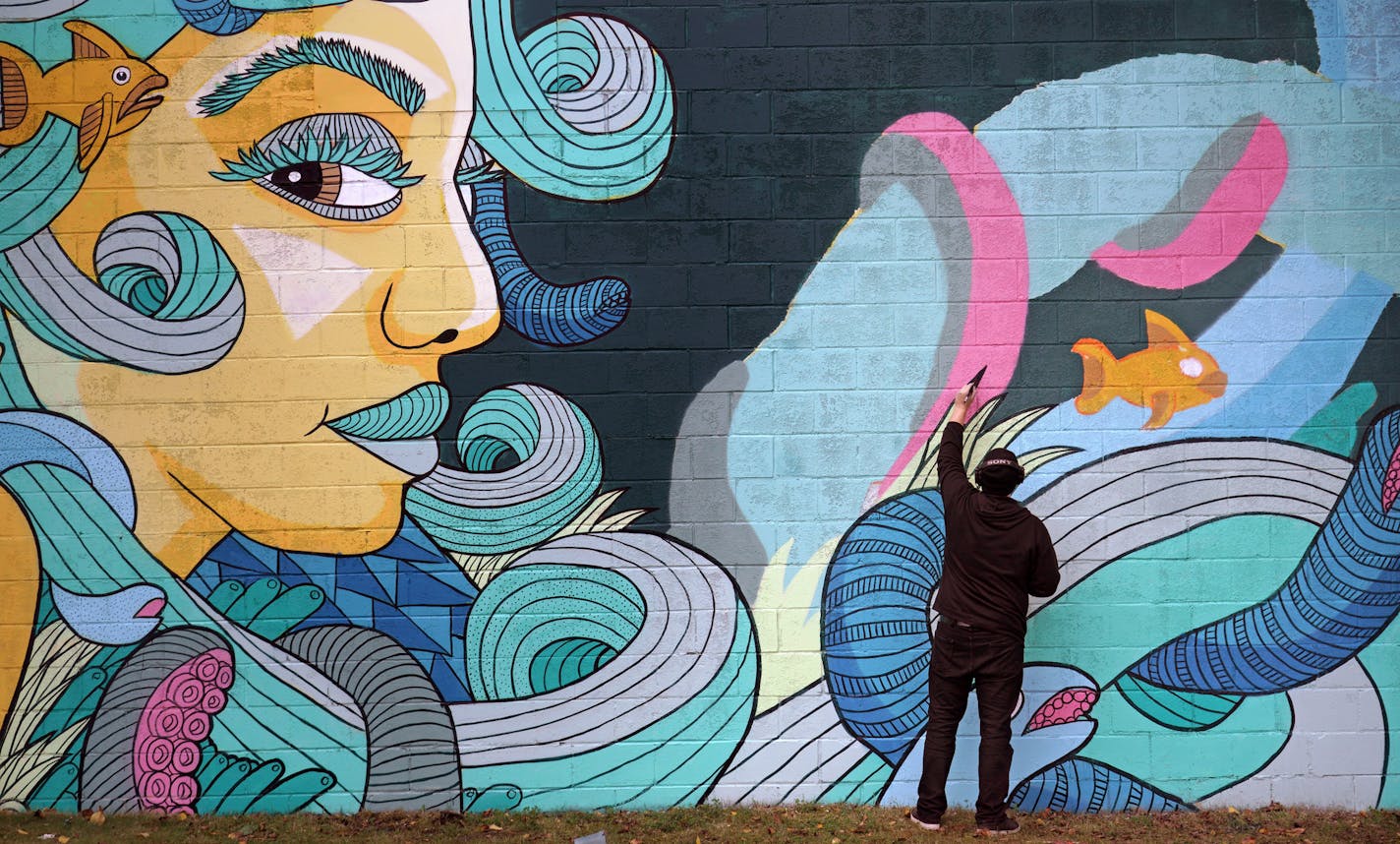 Chroma Zone Mural Fest is the first-ever event of its kind, with 15 artists creating 12 large outdoor murals in St. Paul's Creative Enterprise Zone. Here, Minneapolis artist Chuck Ungemach works on his mural at 2290 Wycliff Street in St. Paul. ] brian.peterson@startribune.com St. Paul, MN Wednesday, September 11, 2019 ORG XMIT: MIN1909131713401292