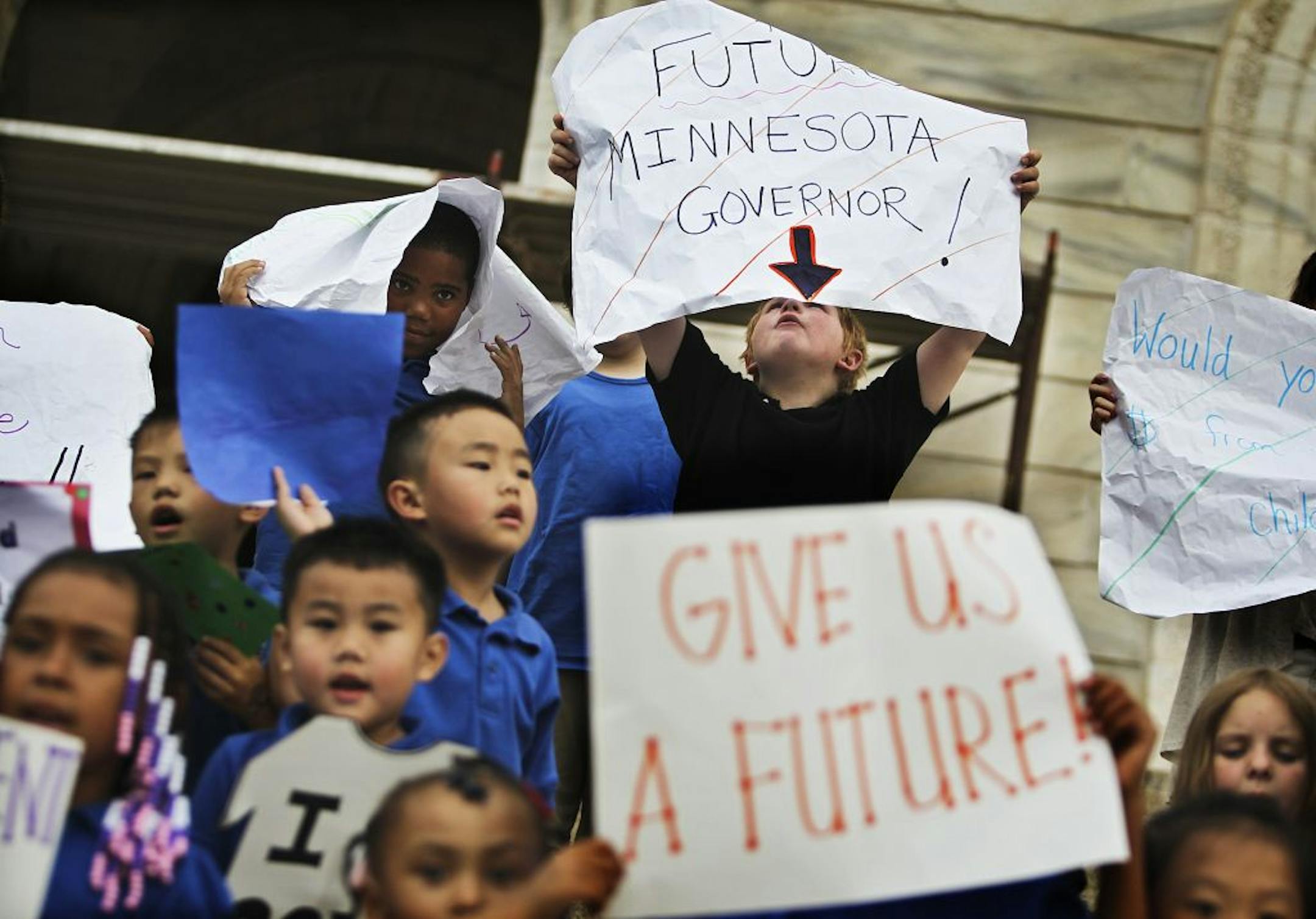 Cameron Walker, a third-grader at Concordia Creative Learning Academy, upper right, joined hundreds of students on the steps of the Capitol at a Tuesday rally to support charter schools.