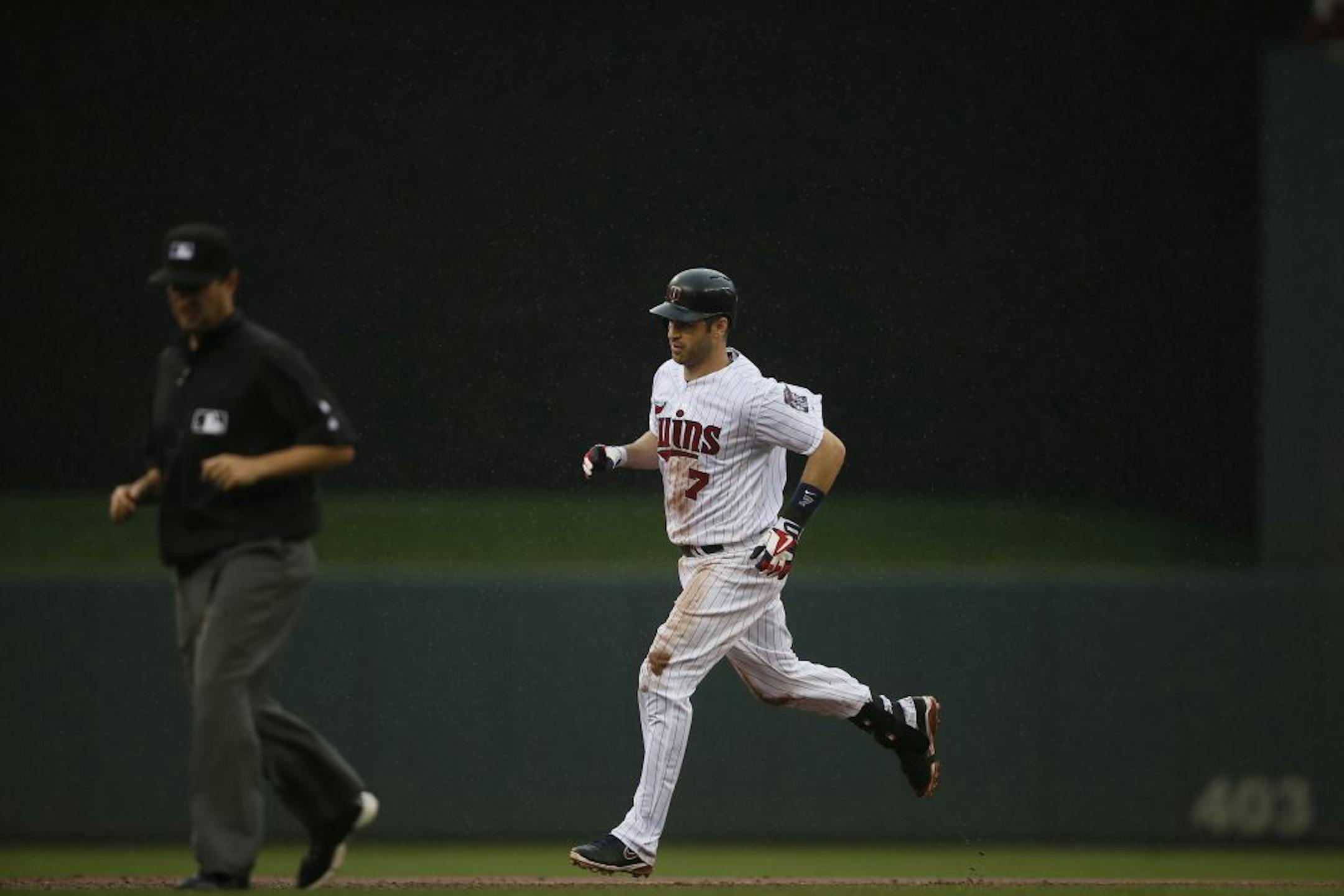 Minnesota Twins first baseman Joe Mauer (7) rounded the base after hit a home run in the third inning at Target Field Sunday August 17 , 2014 in Minneapolis MN .