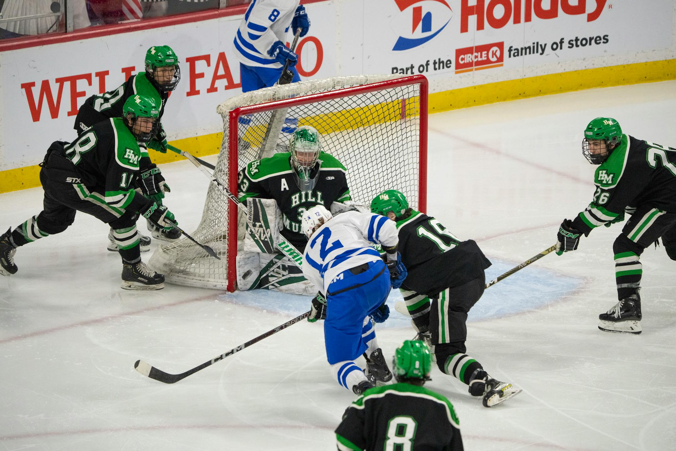 Hill-Murray Pioneers goaltender Jack Erickson (33) stopped a shot by Minnetonka Skippers forward Alex Lunski (12)  in the third period.