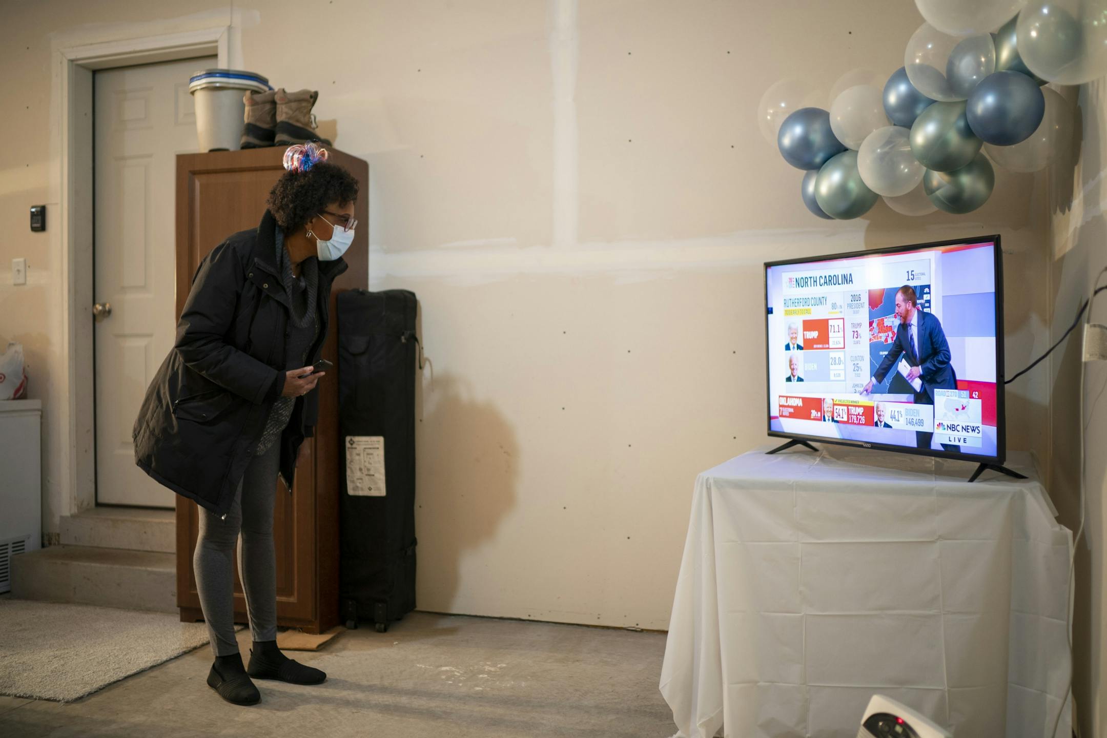 Linda Garrett-Johnson watched election returns while attending an election party in her friend's garage.