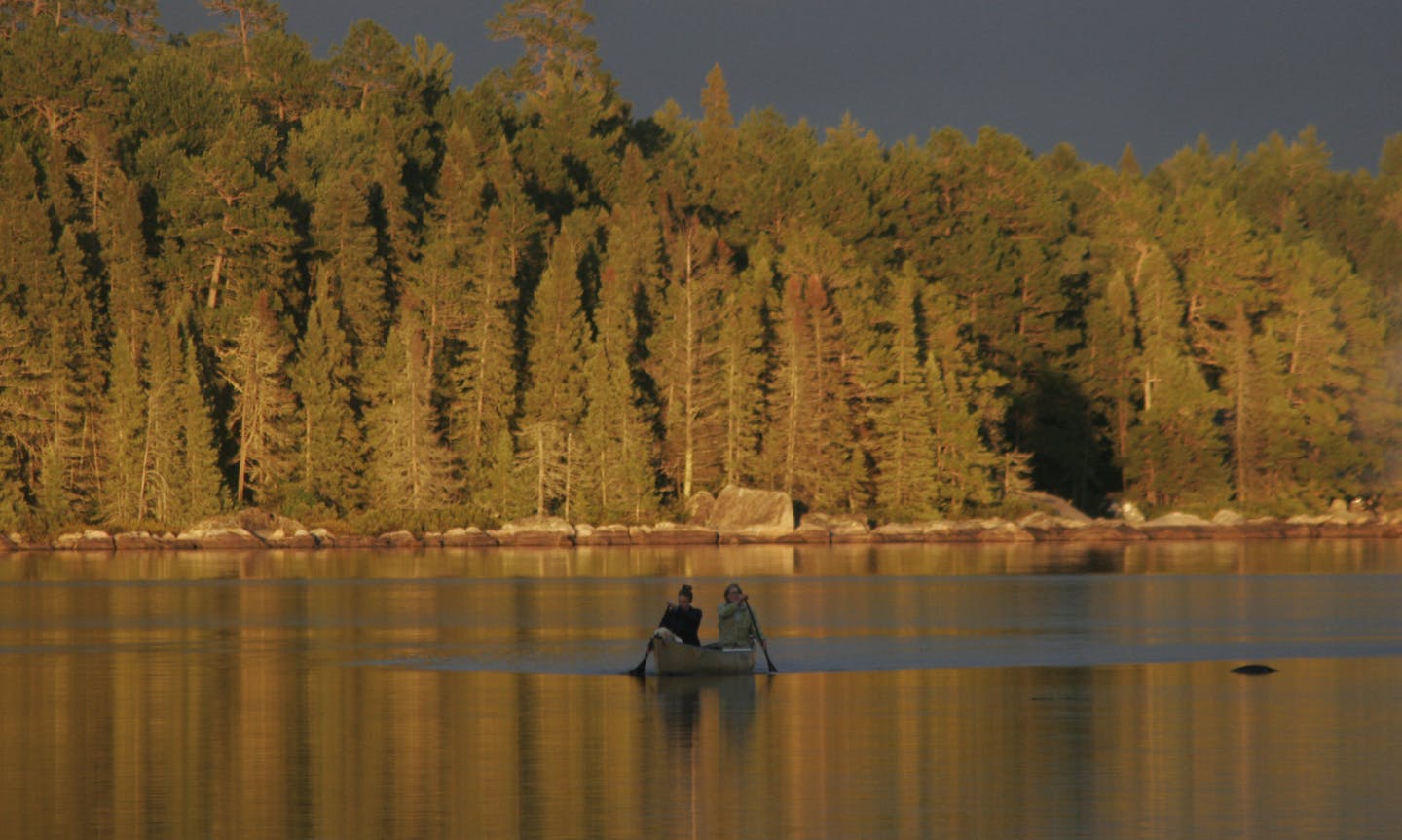 Sun broke through clouds late in the day, lighting up the eastern shore of a BWCA lake last week. Enjoying the quiet waters were Kelly and Mary Lynn Smith of the Twin Cities.