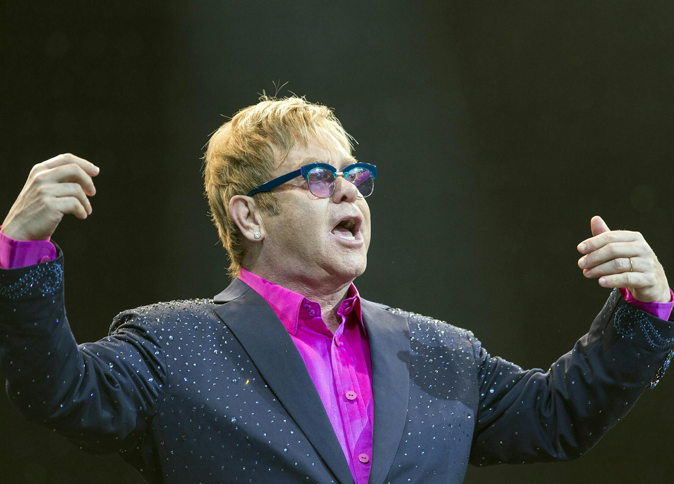 In this picture made available Friday, Sept. 6, 2013, Sir Elton John performs on the Waldbuehne stage in Berlin, Germany, Thursday, Sept. 5, 2013. British musician John gives five concerts in Germany during his 'Greatest Hits Live Tour 2013'. (AP Photo/dpa, Florian Schuh) ORG XMIT: MIN2013100308473404