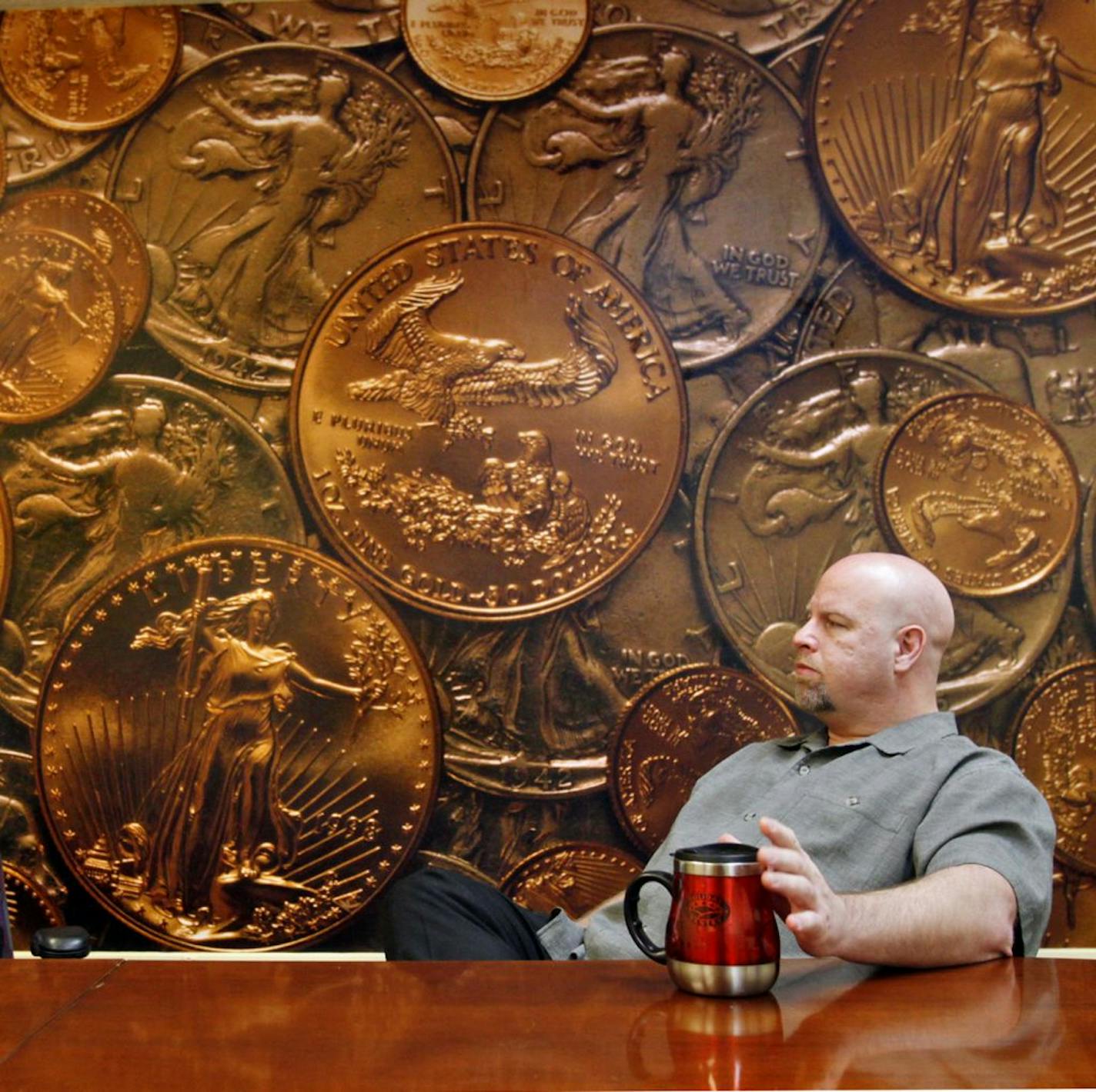 With a conference room papered in gold coins, co-owners Shaun Waste, right, and Ray Hanisco, discussed the industry. (EDITOR'S NOTE: HANISCO SAID HE DID NOT WANT TO BE PHOTOGRAPHED AND COVERED HIS FACE DURING LATER ATTEMPTS).